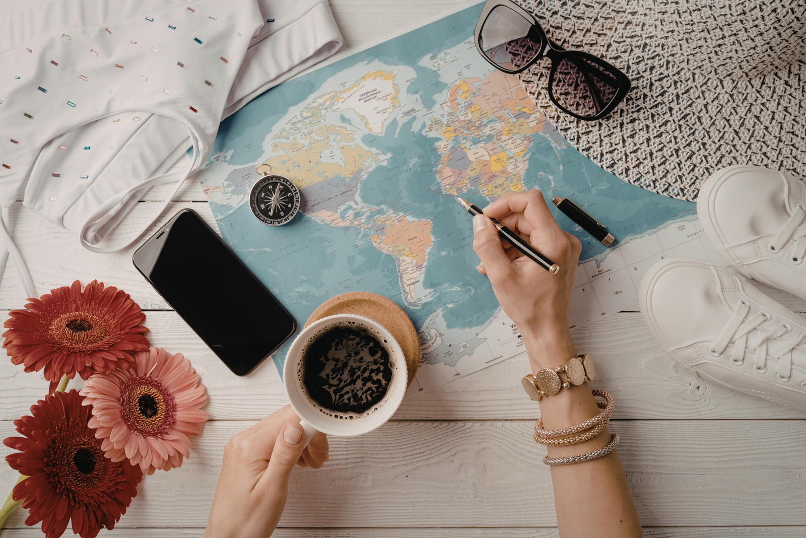 travel planning flat lay with world map and coffee for National Plan for Vacation Day