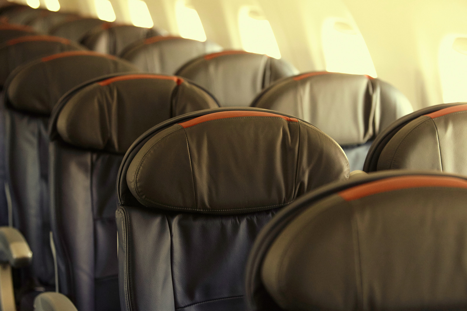 Rows of economy airplane seats, featured for a guide on the best seats on airplanes and the worst seats on airplanes