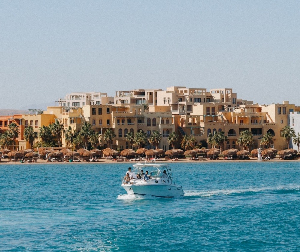 Boat on the Red Sea in El Gouna Egypt with waterfront resort buildings