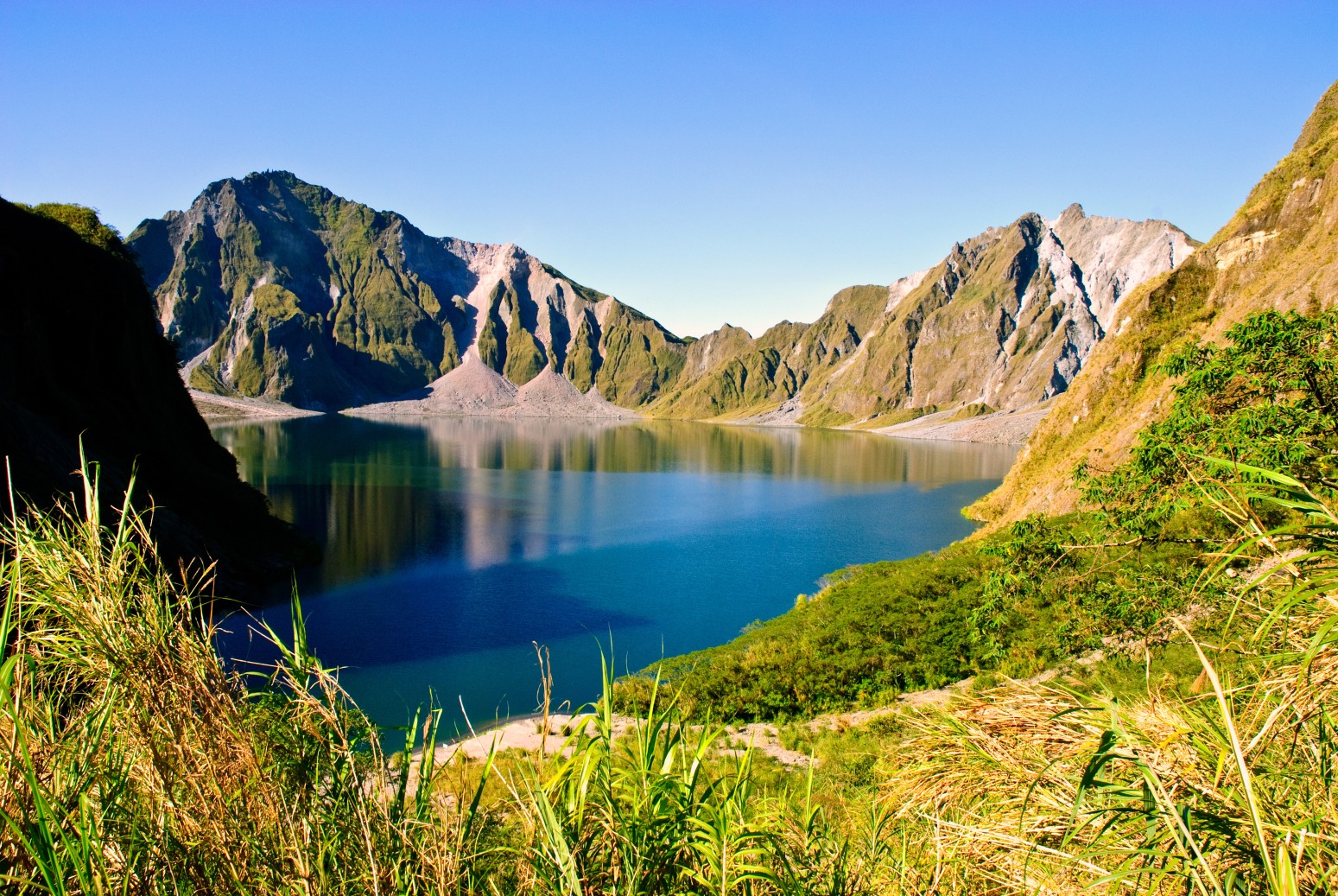 view of the crater lake of Mount Pinatubo volcano in Luzon, Philippines. The volcano erupted in July 1991, causing significant global environmental effects.