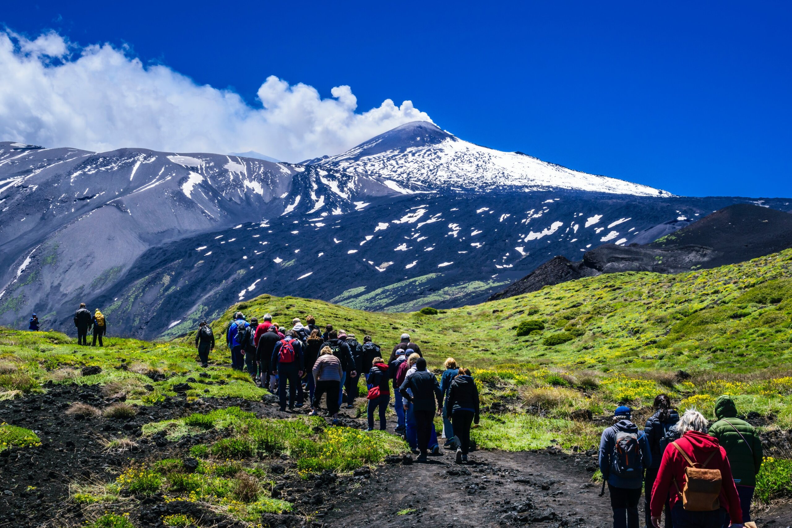 Hikers on Mount Etna Against a Dramatic Landscape