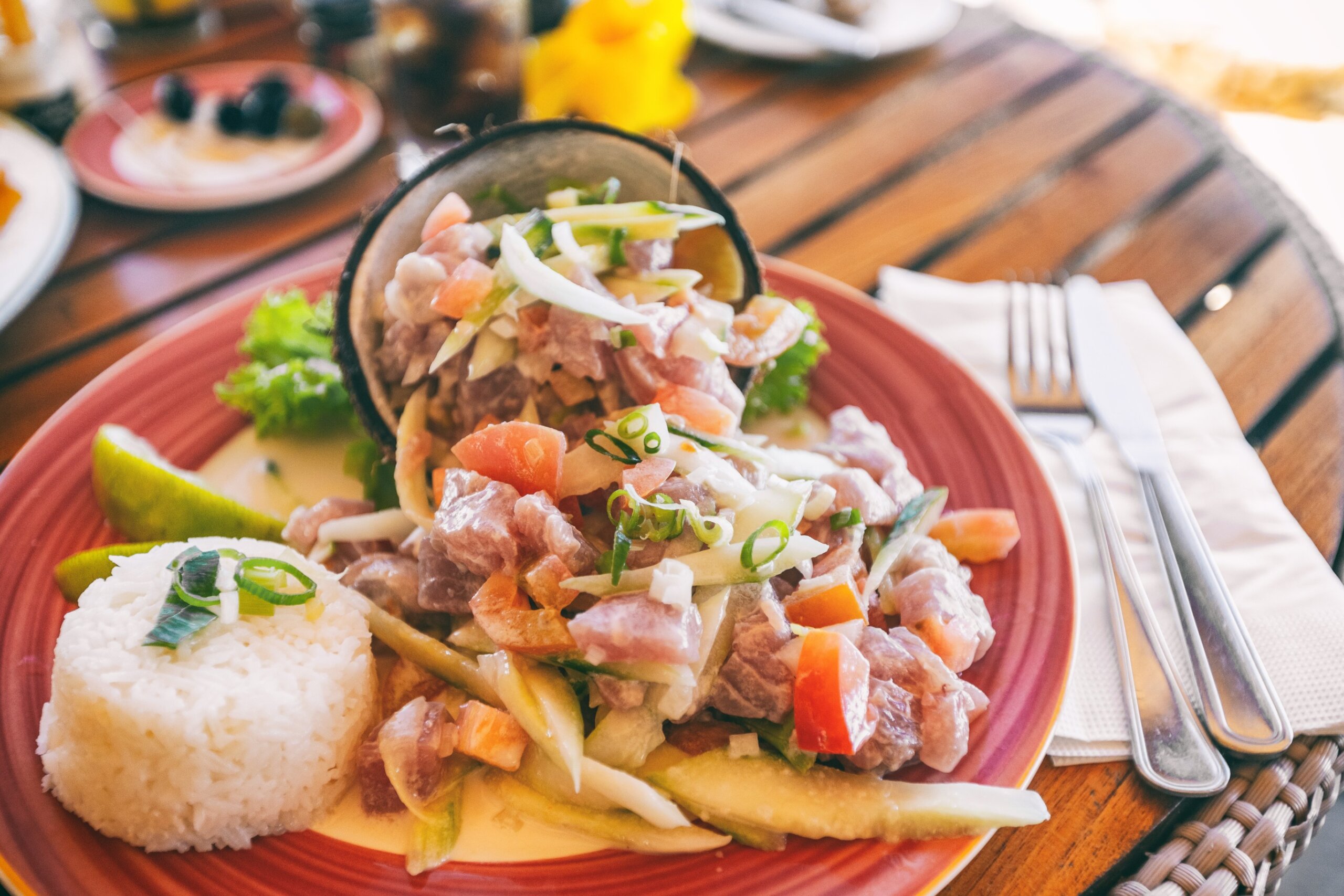 Tahiti food National dish local typical cuisine - Tahitian Raw Fish salad called Poisson Cru in French Polynesia. Top view of hotel restaurant meal in Bora Bora