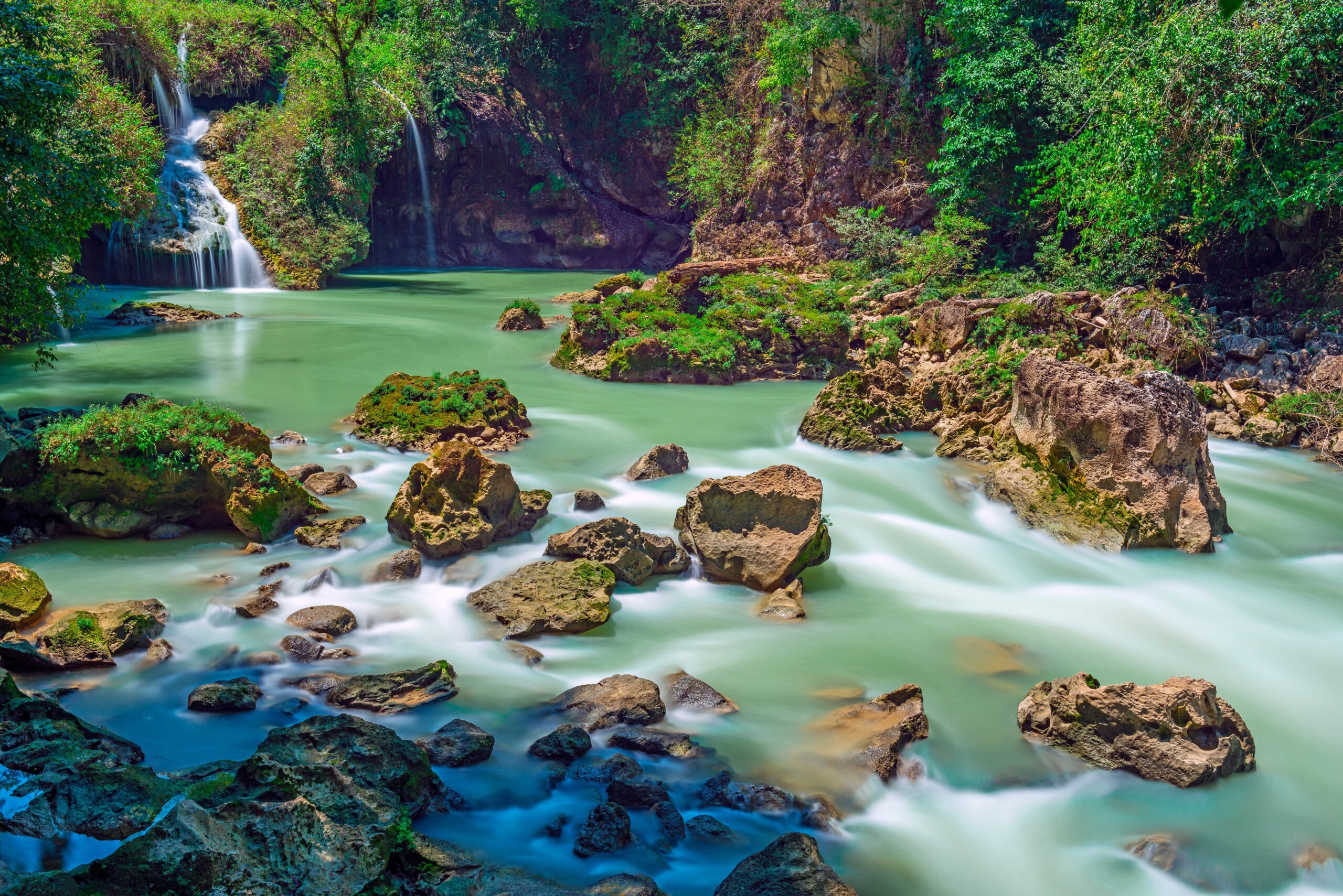 Turquoise pools and jungle river at Semuc Champey Guatemala surrounded by rocks and rainforest