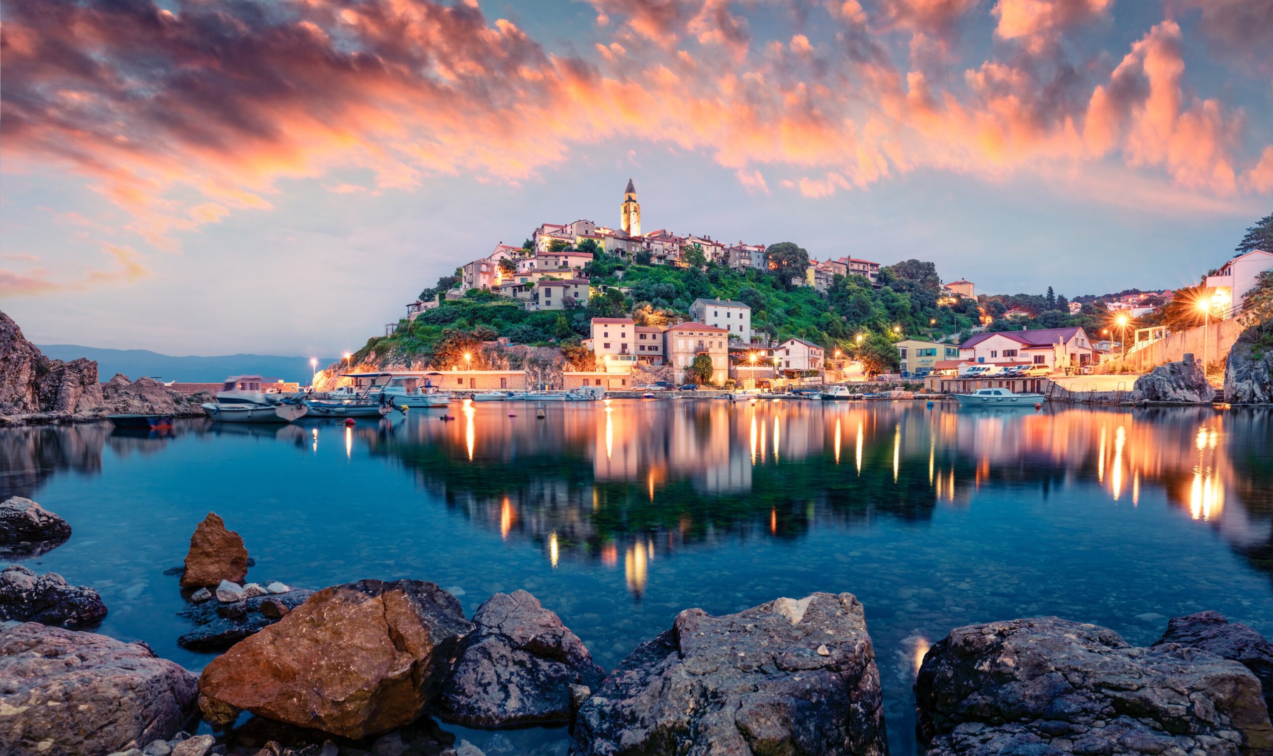 Sunset over a Croatian coastal town on the Adriatic Sea showing why Americans love Croatia