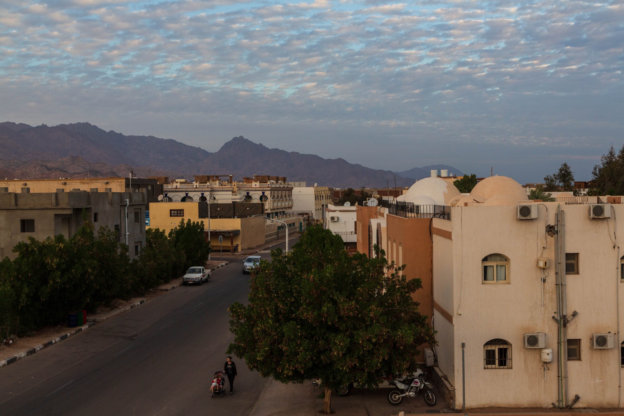 Local houses, beautiful cloud in the sky, mountains on the horizon during sunset. Dahab, Sinai peninsula, Egypt
