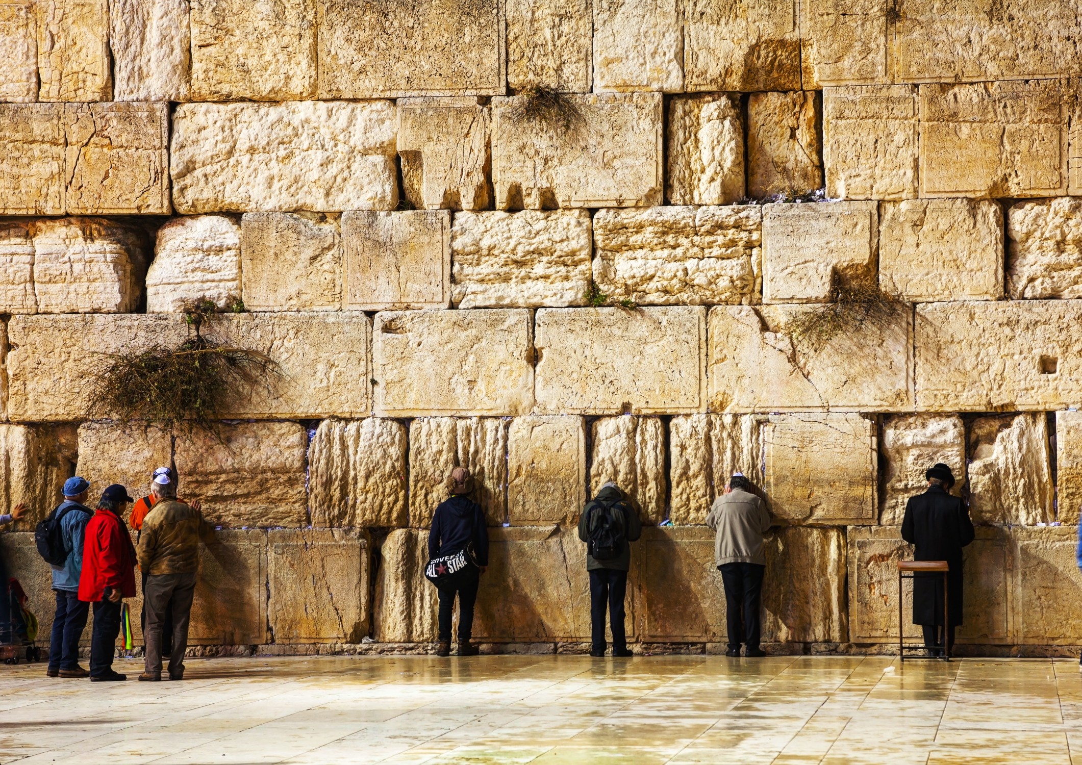 People praying at the Western Wall in Jerusalem, showing religion and public life in one of the most strict religious countries