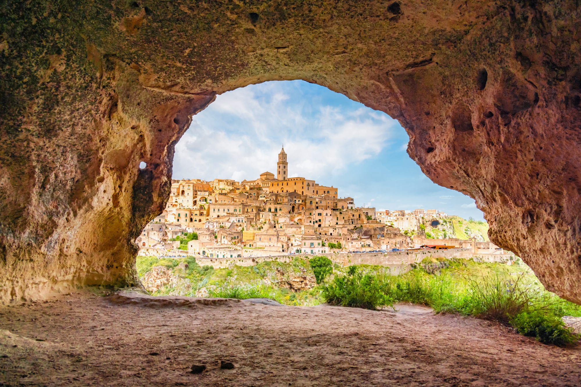 View of Matera Italy and the Sassi di Matera framed by a cave opening