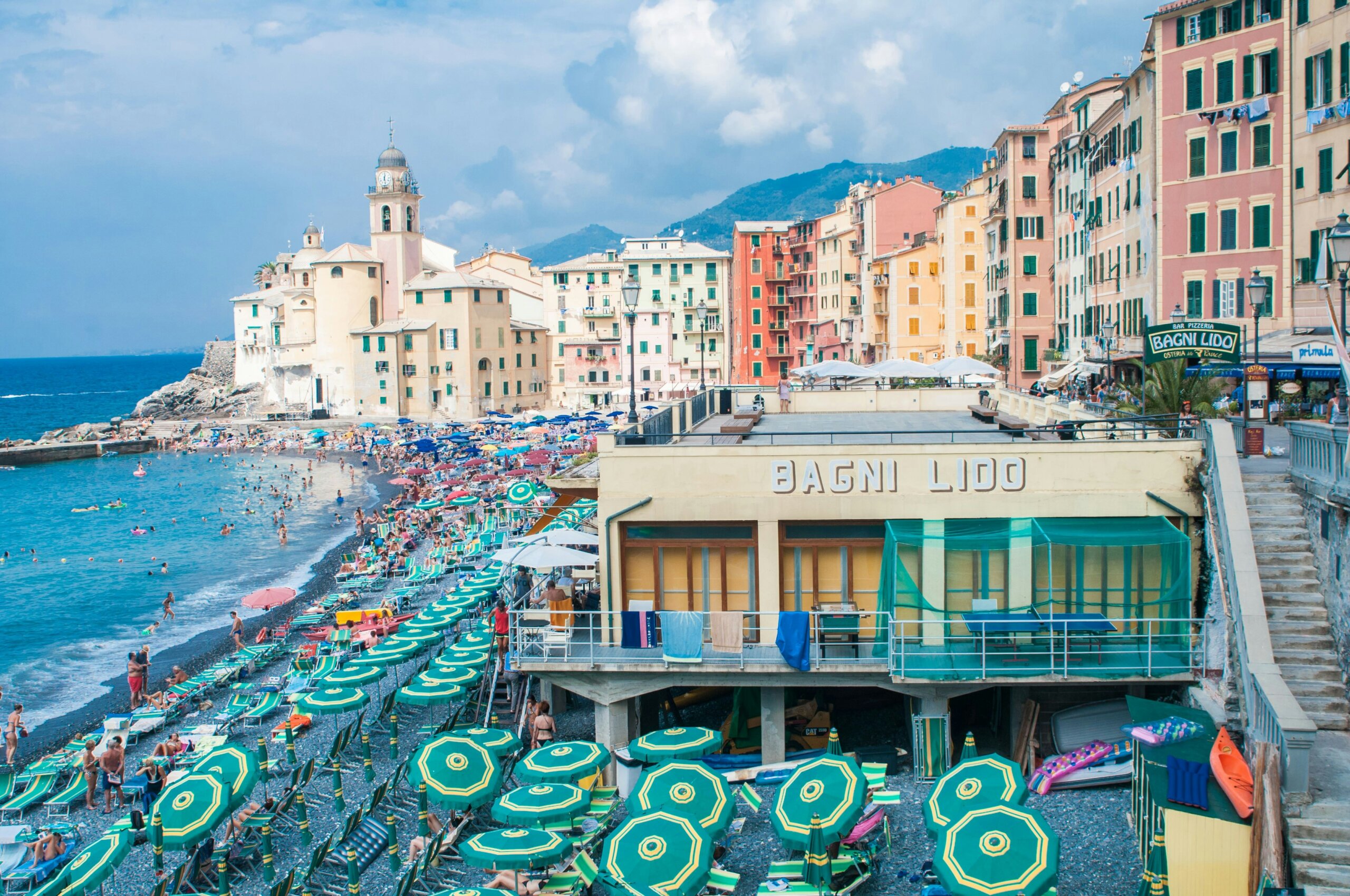 camogli - Colorful Italian seaside town with beach umbrellas and waterfront buildings