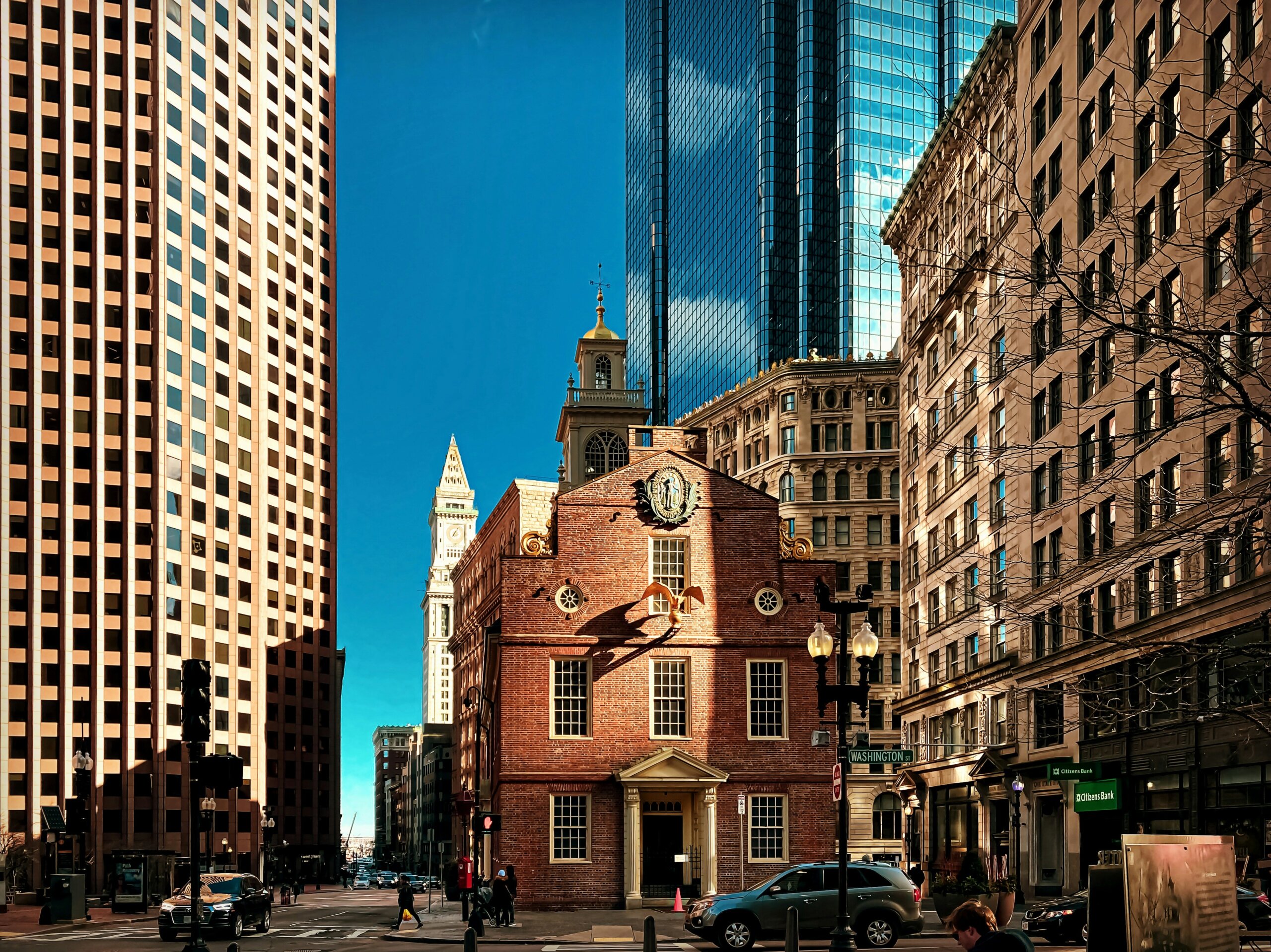 Downtown U.S. city street with historic building and skyscrapers for article on America’s rudest cities