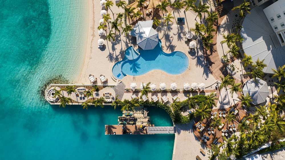 Aerial view of beachfront all-inclusive resort in Turks and Caicos with turquoise water and pool