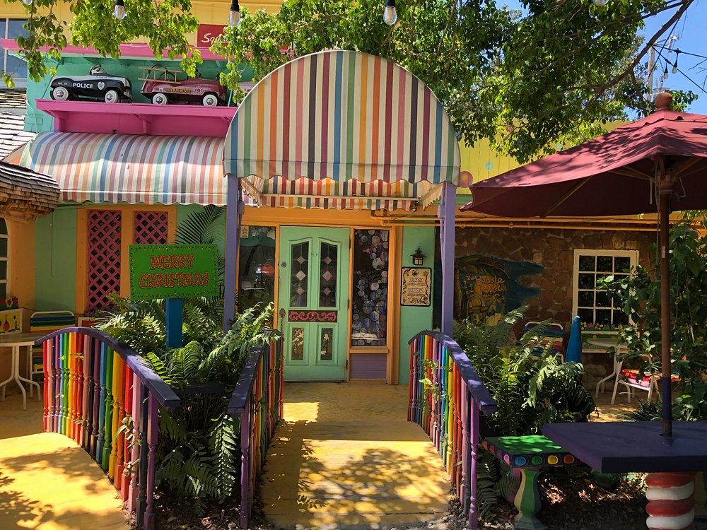 Colorful themed restaurant entrance in Florida with striped awning and bright patio seating