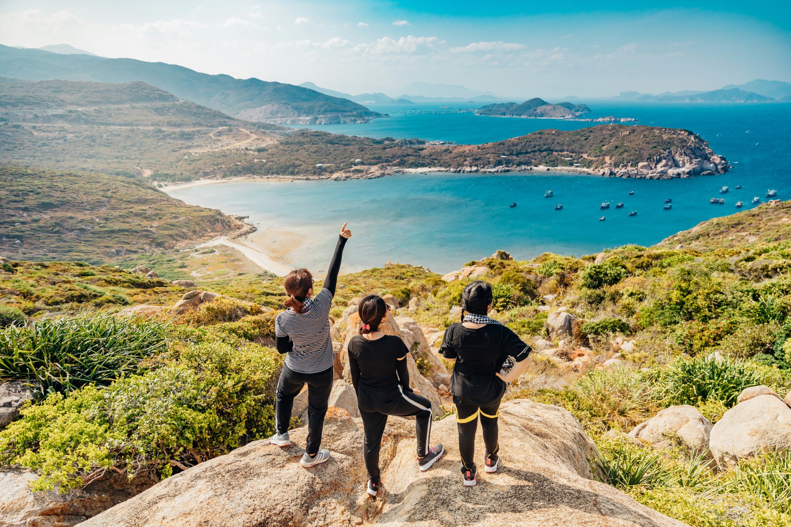 Travelers at a coastal viewpoint during a microcation long weekend trip