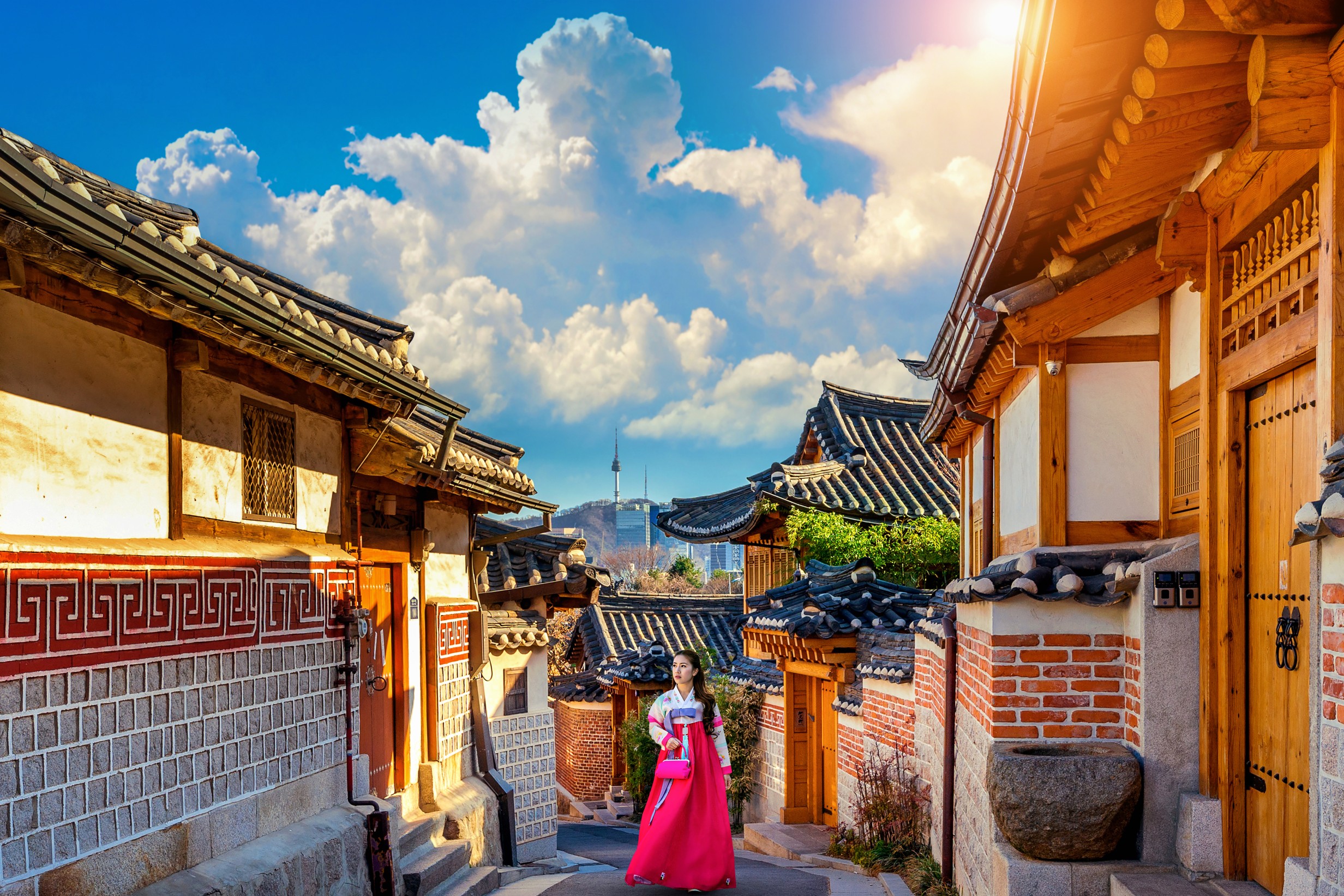 woman wearing hanbok walking through Bukchon Hanok Village Seoul South Korea
