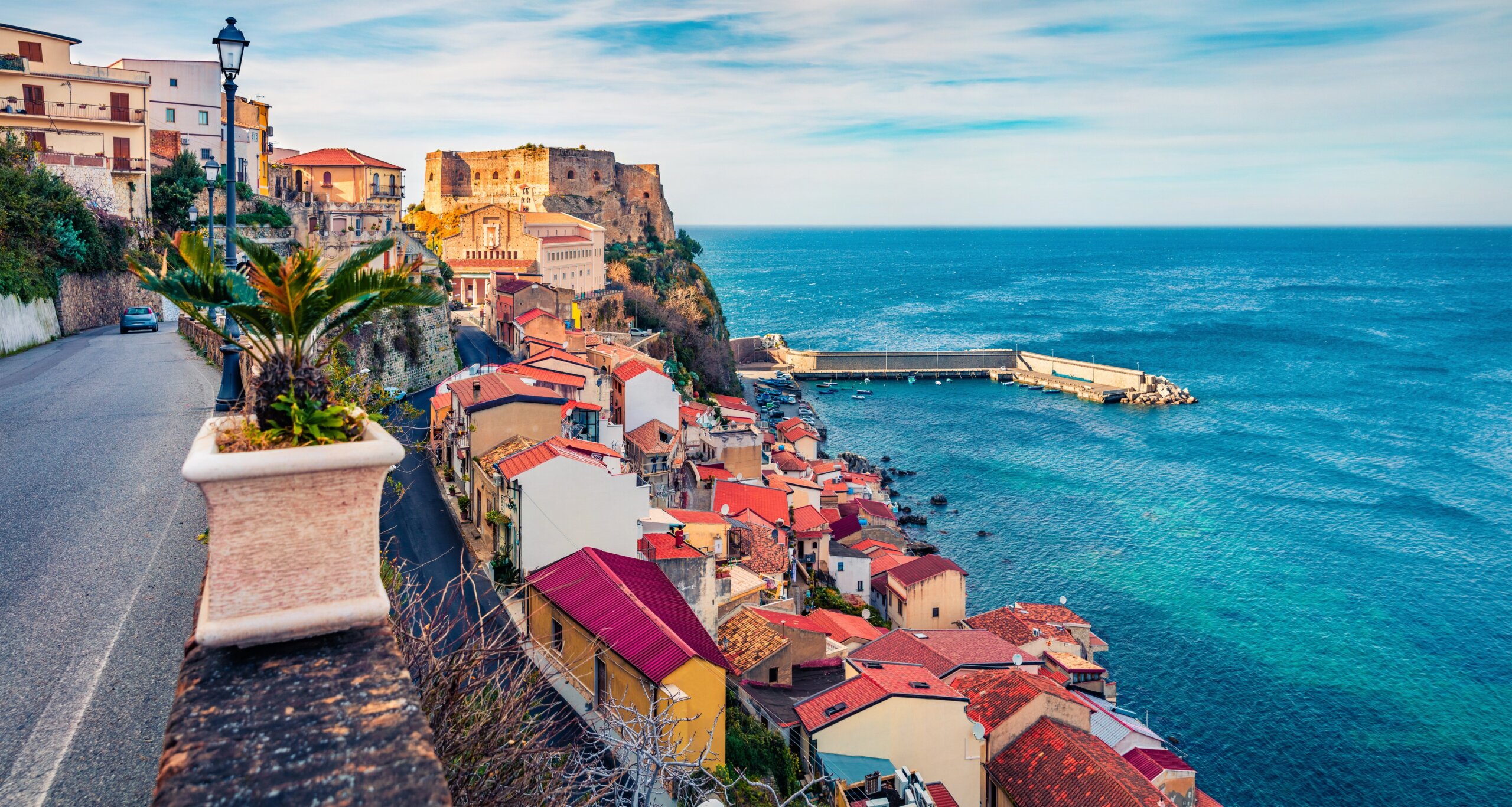 Picturesque morning view of Scilla town with Ruffo castle on background, administratively part of the Metropolitan City of Reggio Calabria, Italy, Europe. Bright summer seascape of Mediterranean sea.