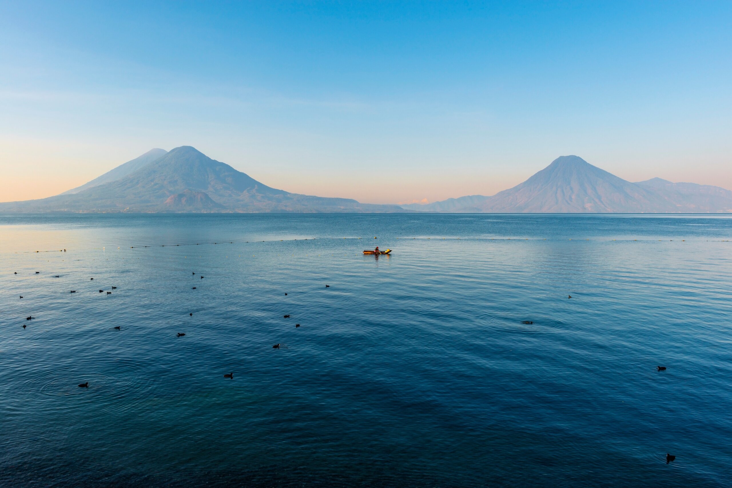 Lake Atitlán with volcanoes and calm water in Guatemala