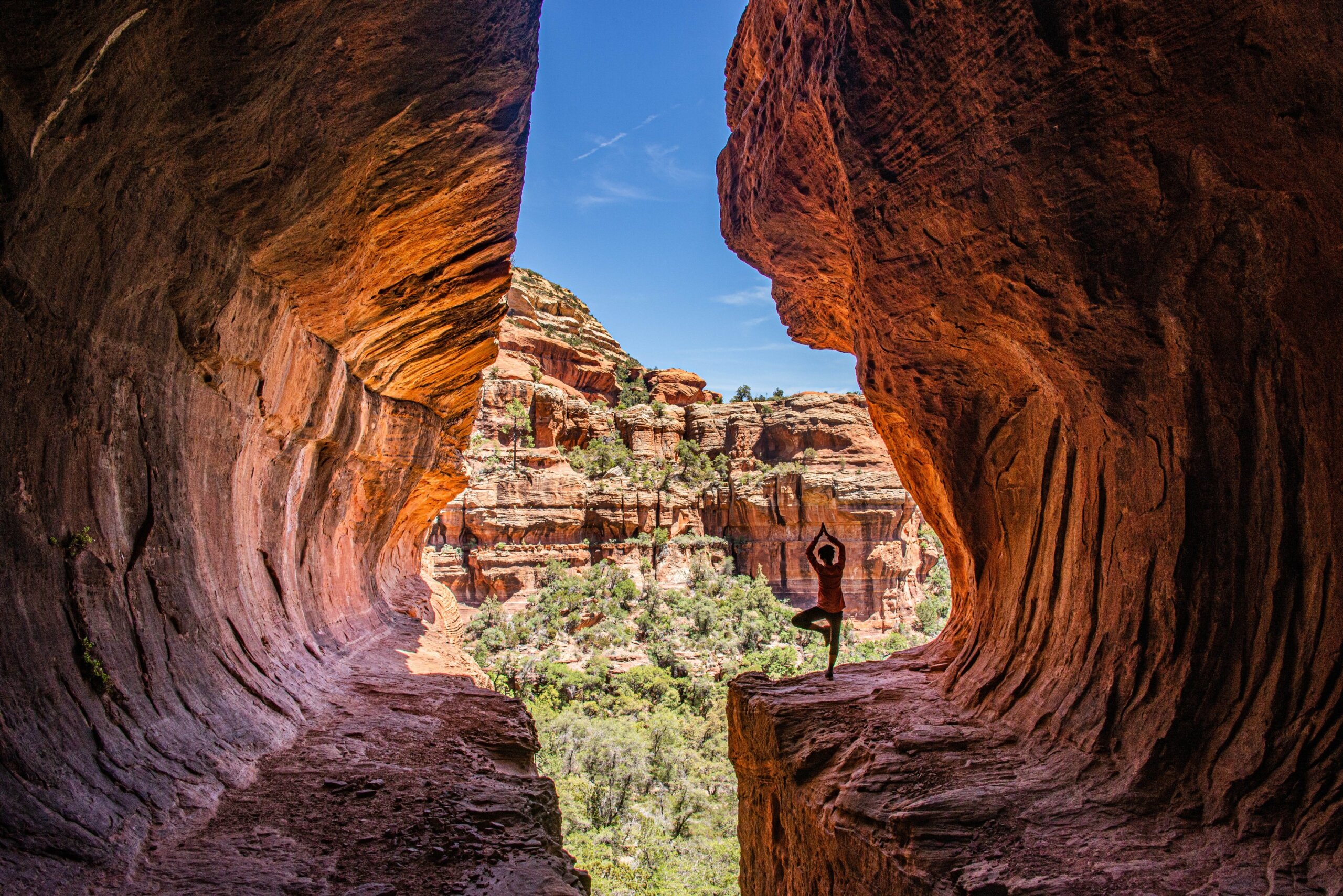 person practicing yoga in a red rock canyon at a beautiful U.S. yoga retreat destination