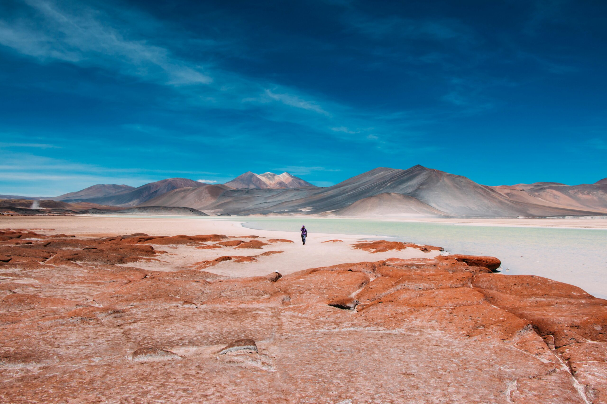 dramatic desert landscape in Chile with mountains and red rock