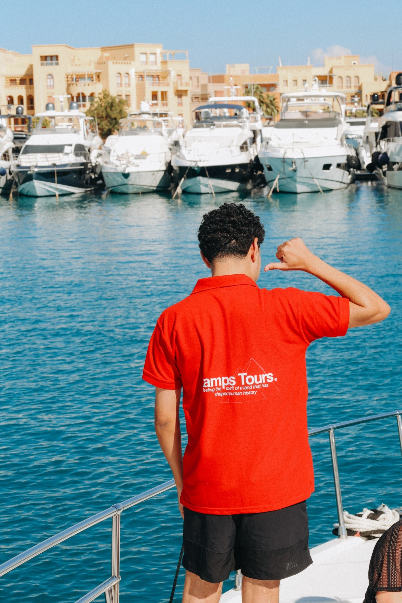 Stamps Tours guide standing on a boat in Egypt marina