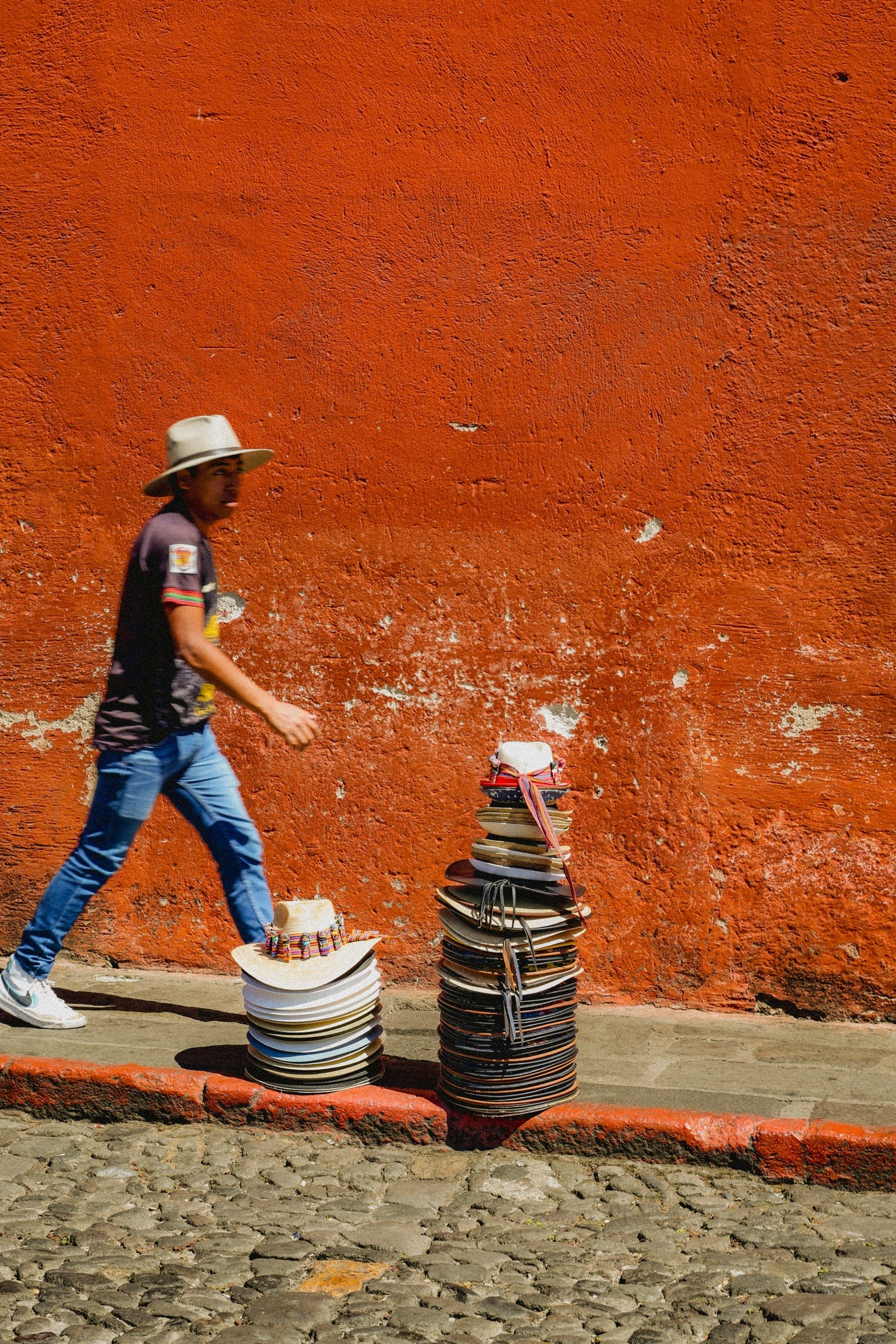 Vendors selling hats, artwork and souvenirs on the streets of Antigua.
