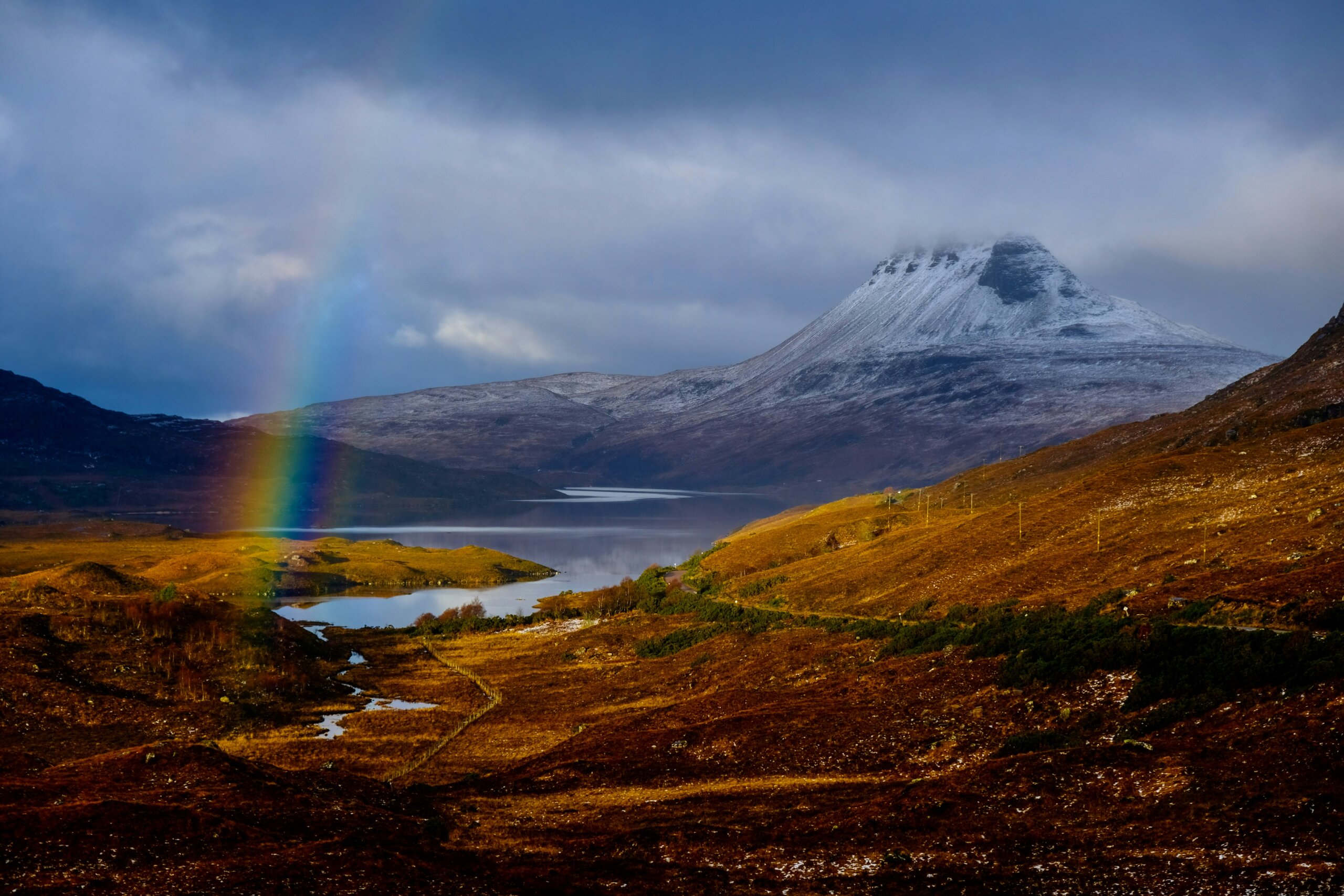 rainbow over mountain landscape on Scotland’s North Coast 500 road trip