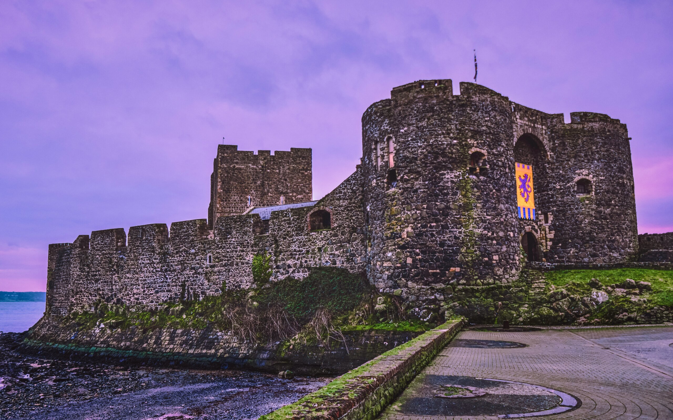 Carrickfergus Castle on the coast in Northern Ireland under a dramatic sky
