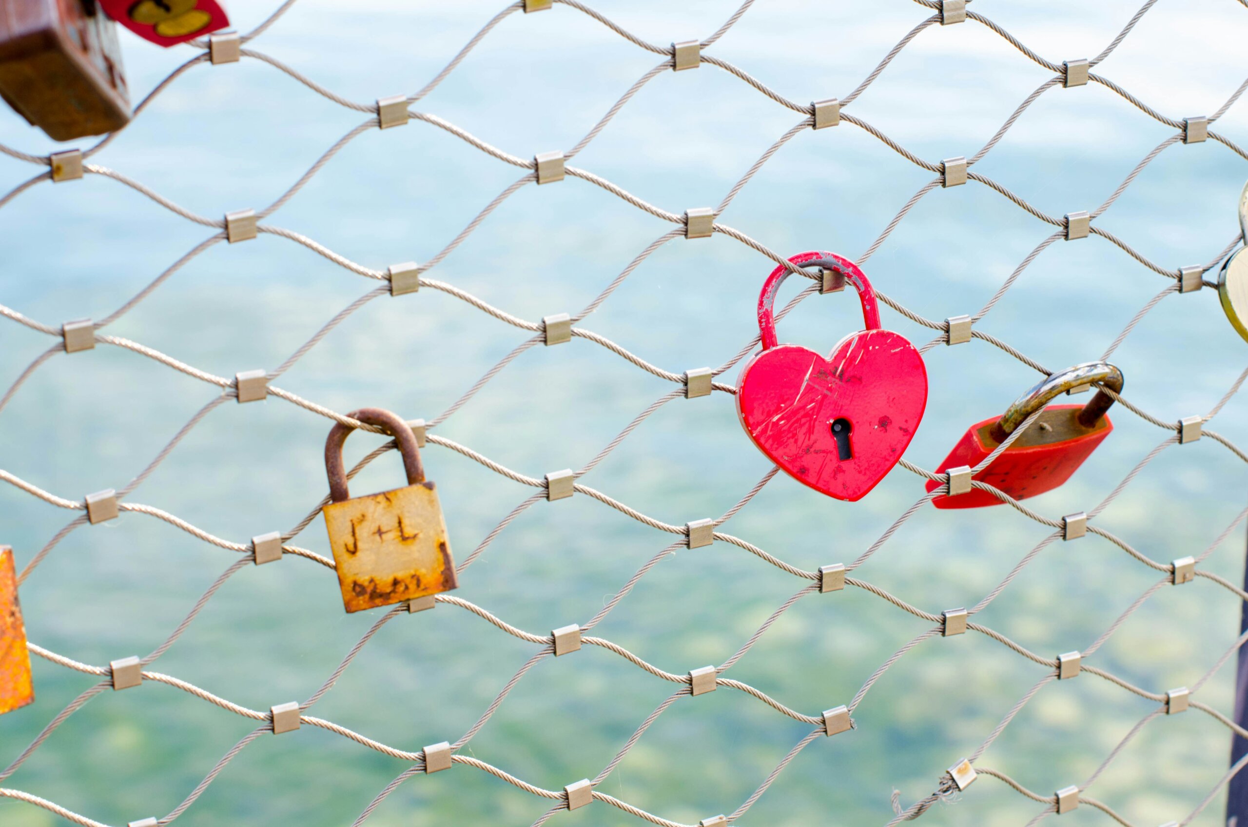 Heart-shaped lock on fence representing romantic travel and couples getaways