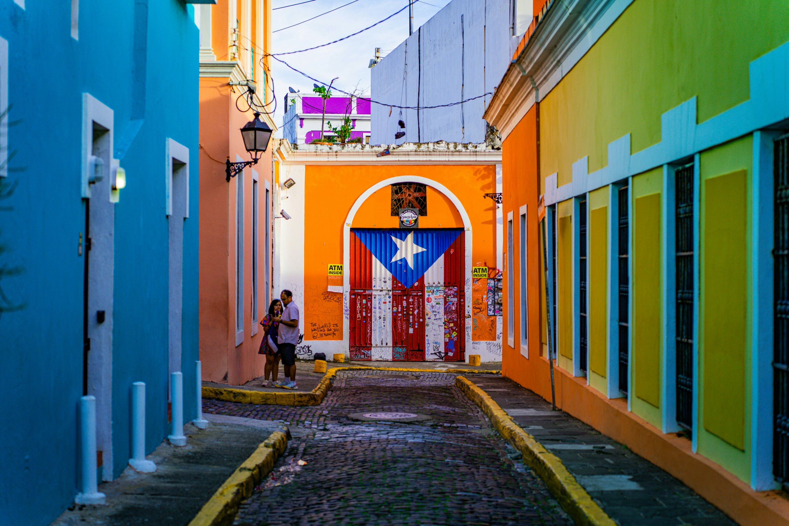 colorful street in Old San Juan Puerto Rico with Puerto Rican flag