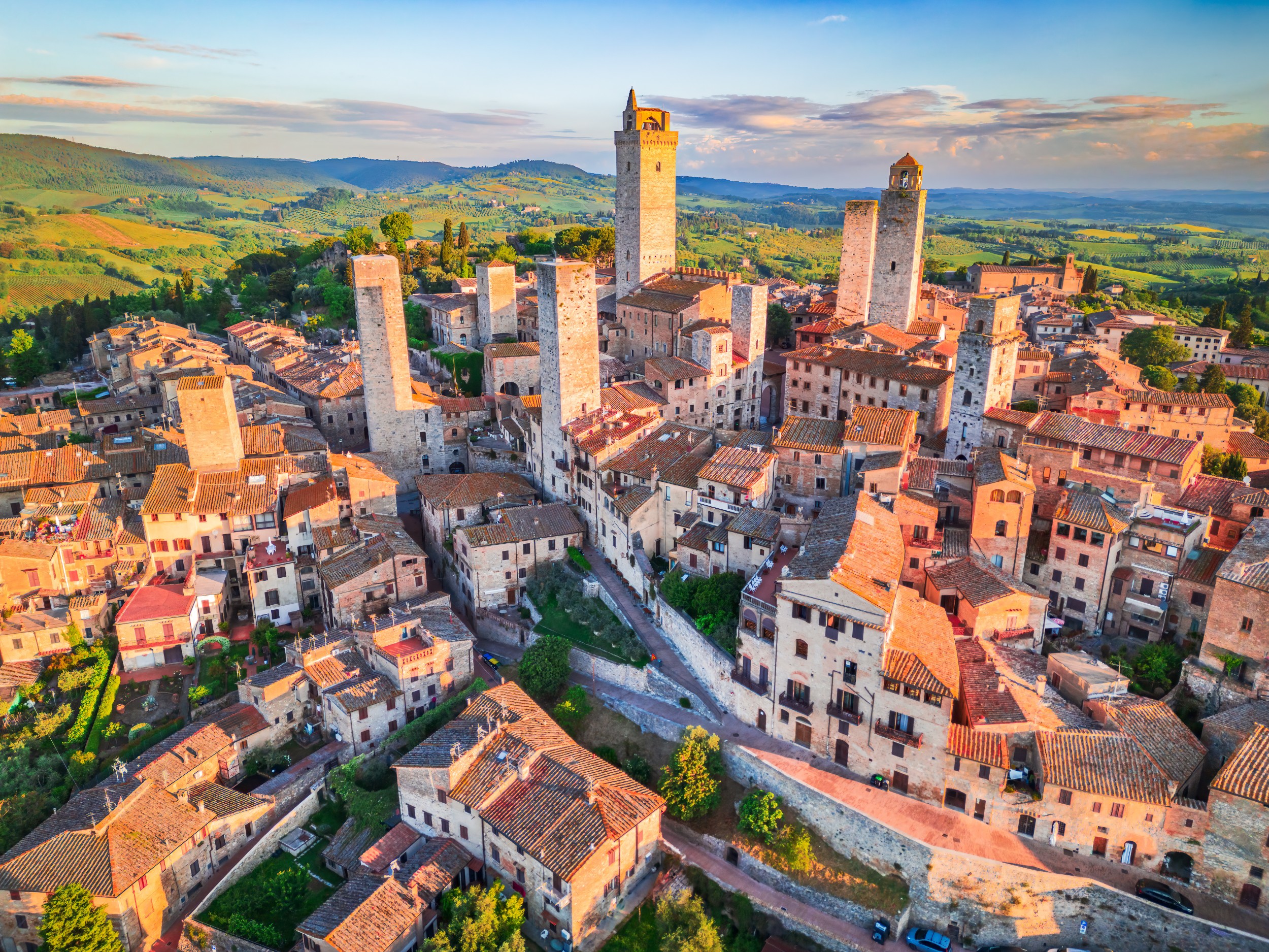San Gimignano medieval towers in Tuscany Italy with historic stone buildings and countryside views