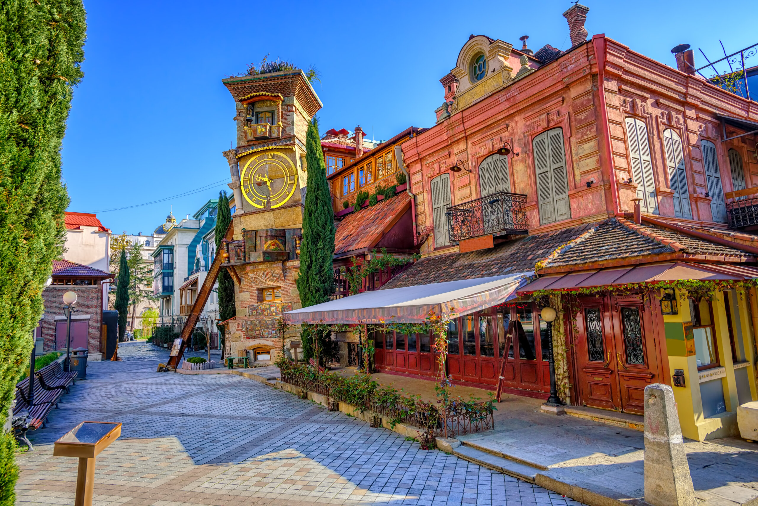 colorful European old town street with clock tower and historic buildings