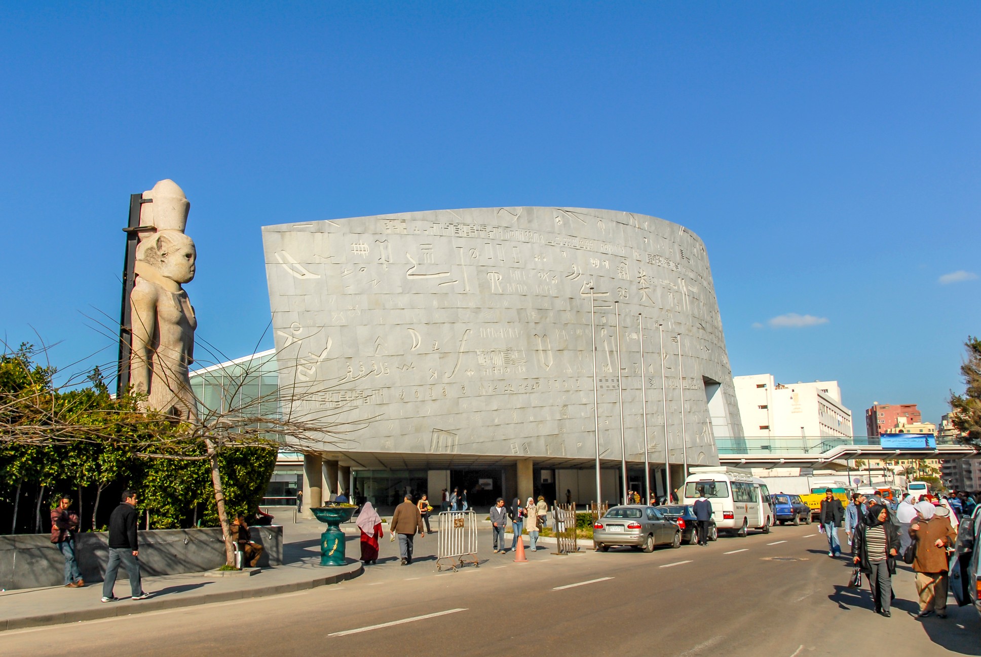 Alexandria, Egypt, 21 February 2018: Library of Alexandria, wall, statue, cars and people
