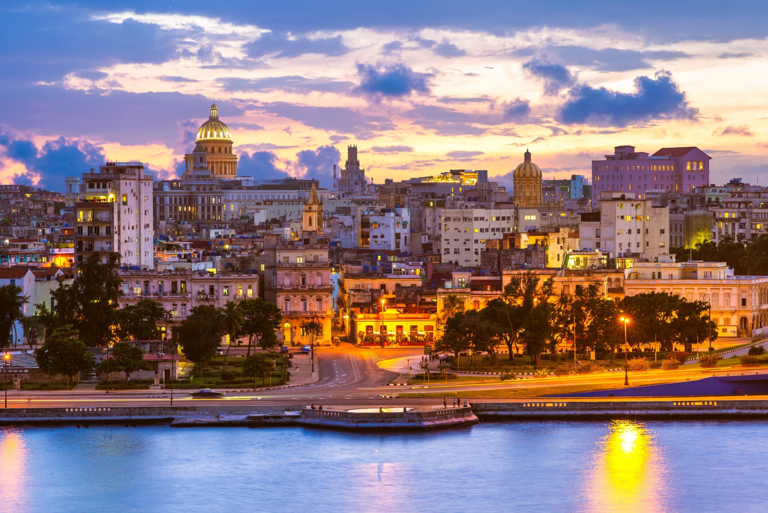 Havana Cuba skyline at sunset with waterfront buildings and glowing city lights