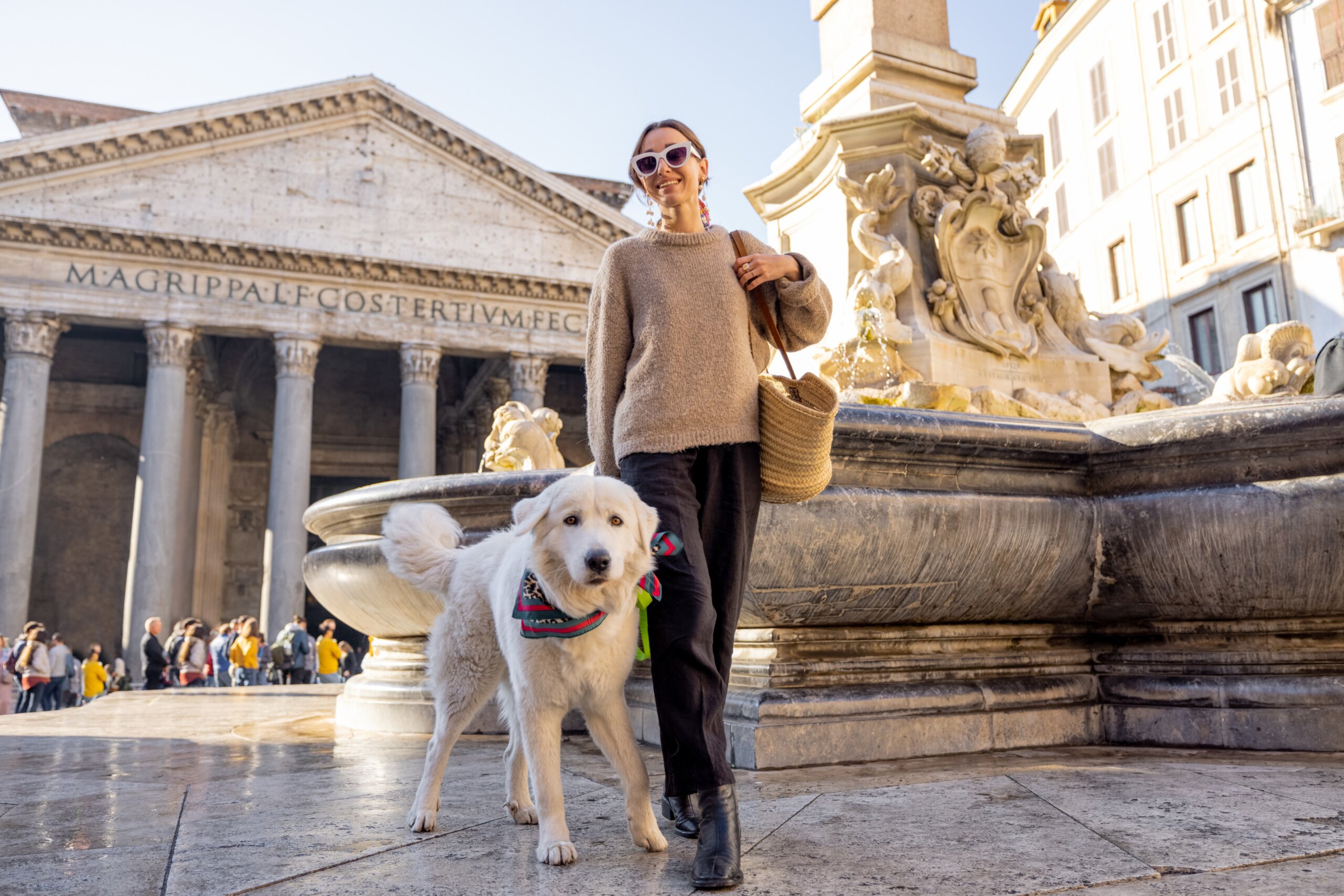 Woman walks with her dog near Pantheon in Rome. Style caucasian woman with her adorable white italian shepherd dog traveling in Italy

