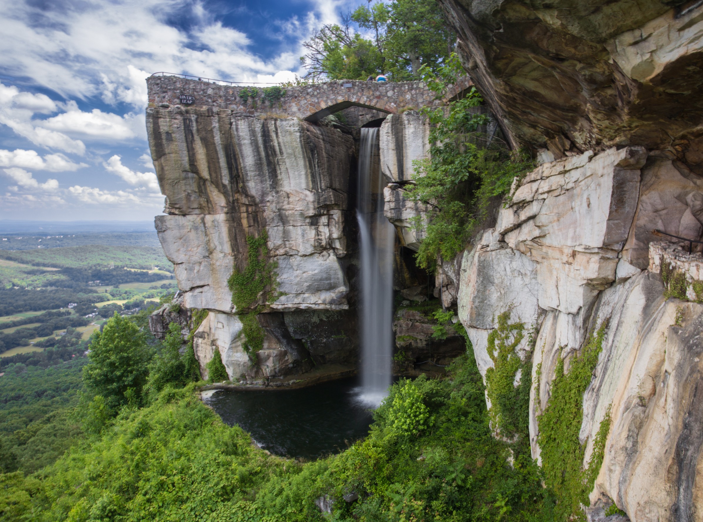 waterfall at Lookout Mountain Georgia surrounded by rocky cliffs and green forest