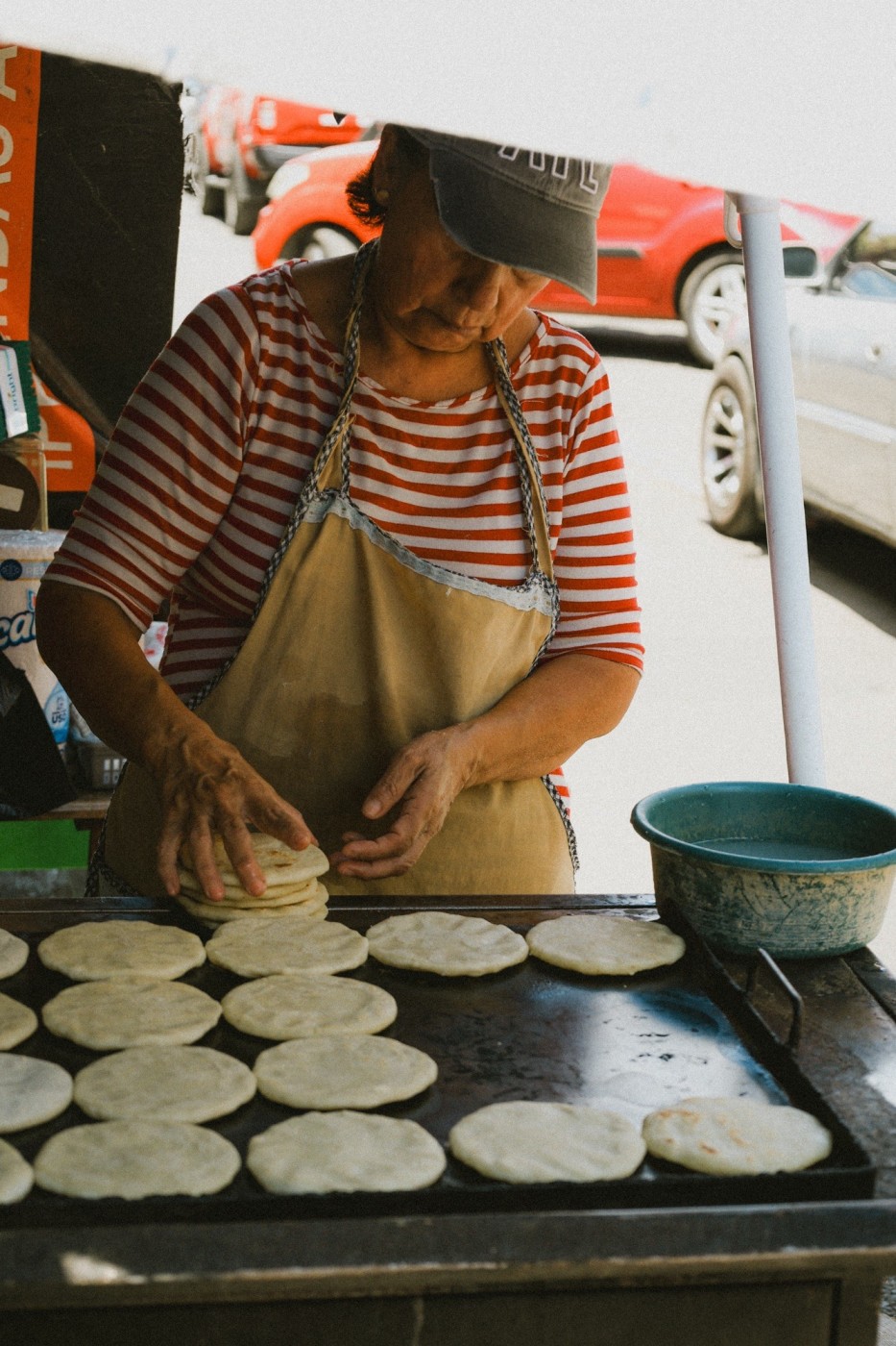 Local woman making tortillas and pupusas at the local market in Santa Ana. 