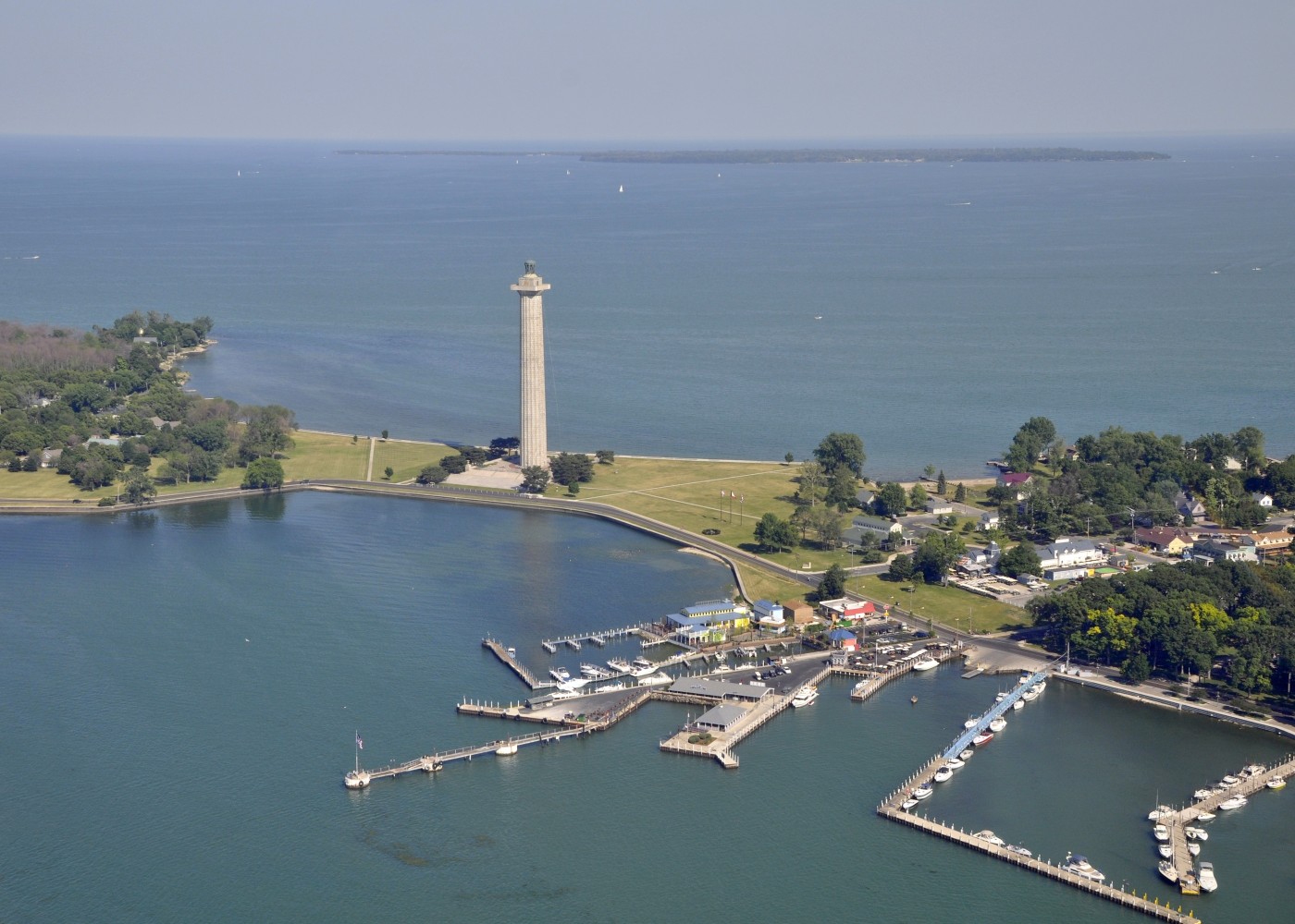 aerial view of Put in Bay's marina and Perry's Victory & International Peace Memorial, Kelley's Island in the far background; Put-in-Bay, South Bass island Ohio USA