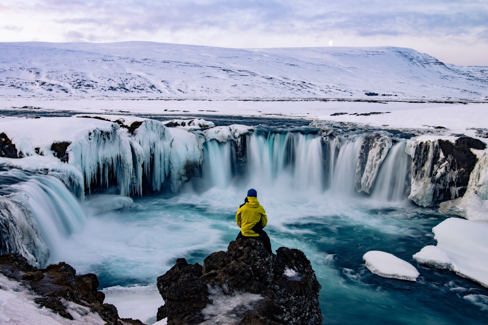 Adventurous man at Godafoss, Iceland in winter
