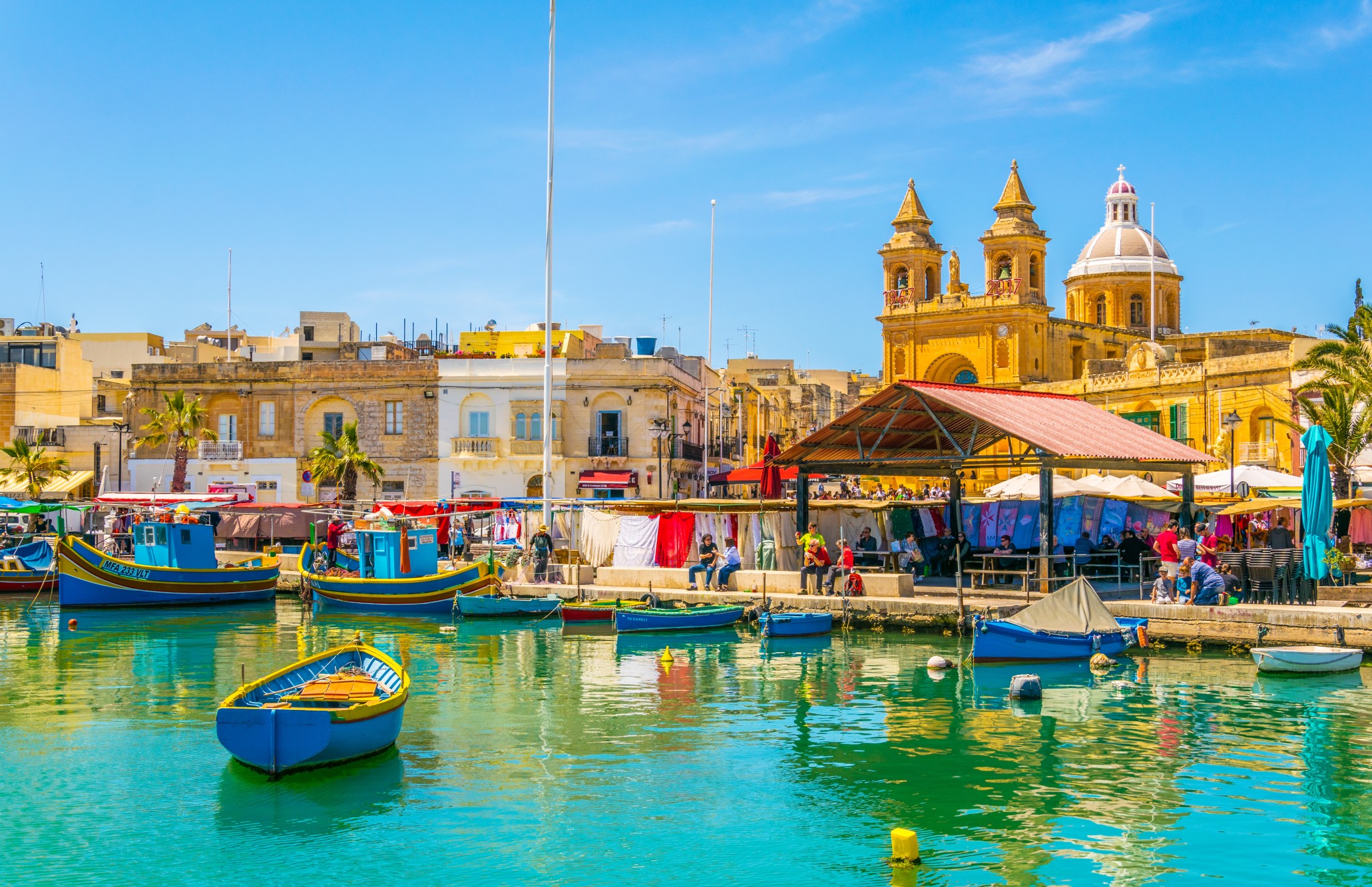 Colorful fishing boats moor in Marsaxlokk, Malta