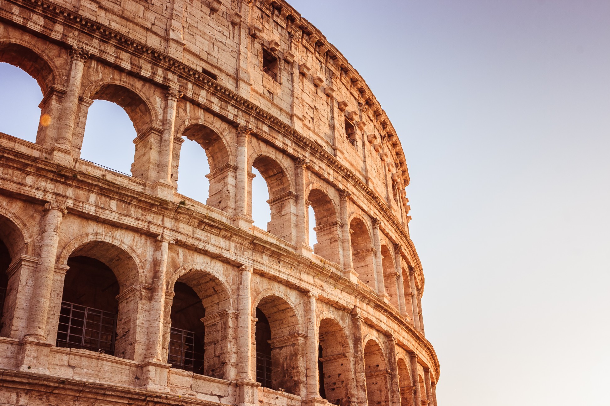 Scenic sunset over the Colosseum. Marble arches ruins over a blue sky, Rome, Italy
