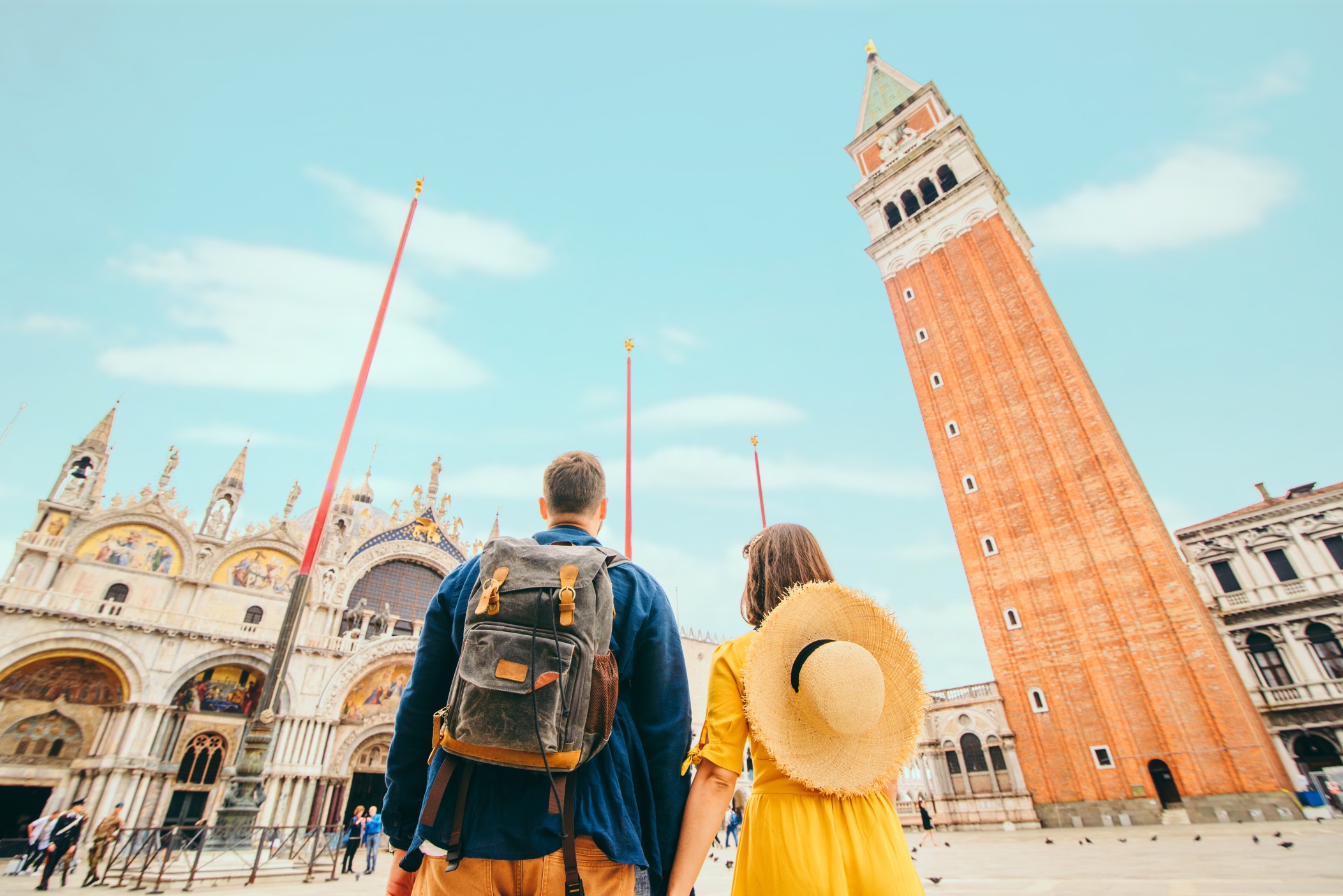 rear view of couple holding hands at saint marks square venice italy