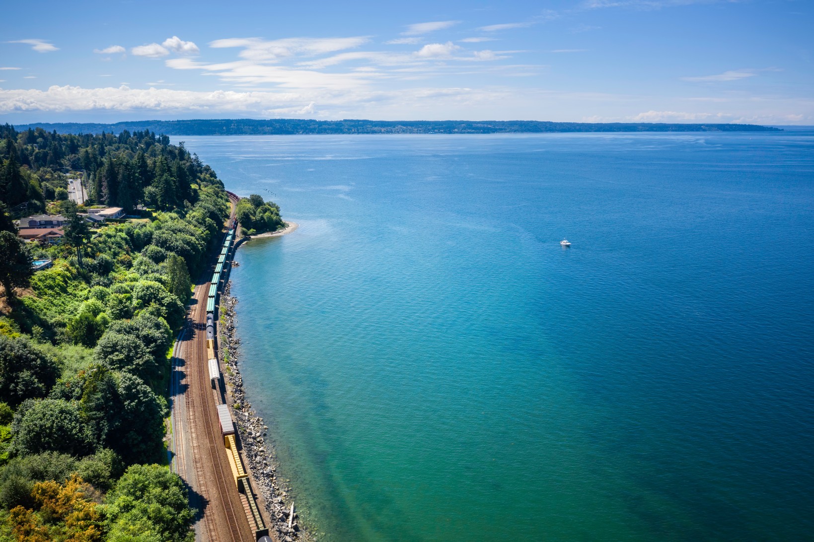Railroad Tracks Curve Along Puget Sound on Sunny Afternoon Day