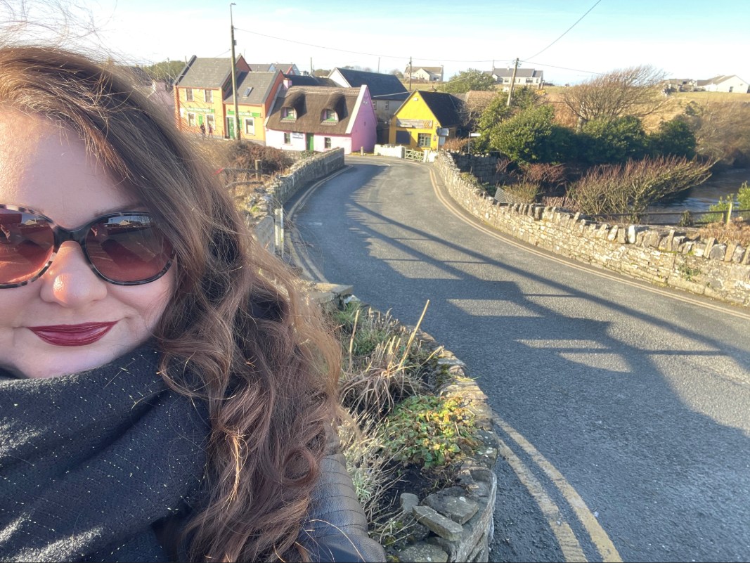 Solo traveler in a colorful Irish village during a solo travel in Ireland journey.