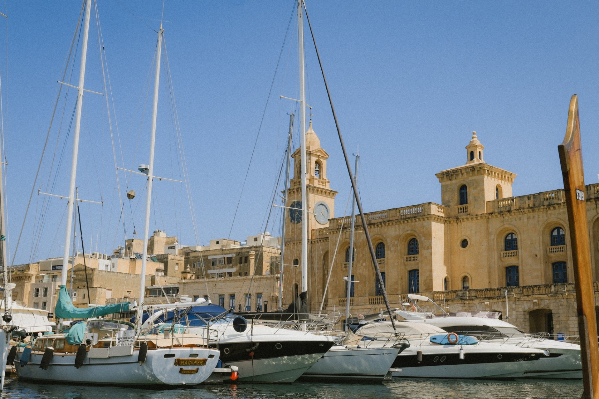Yachts docked along the historic waterfront in Valletta Malta on a sunny Mediterranean day