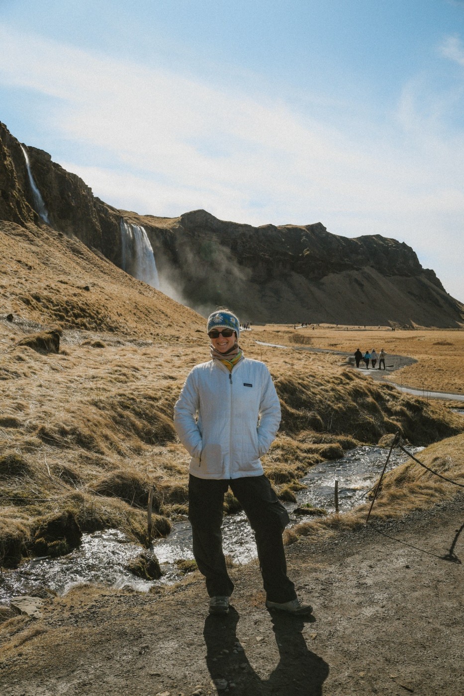 Traveler standing near waterfalls on Iceland’s South Coast during a 3 days in Iceland road trip.