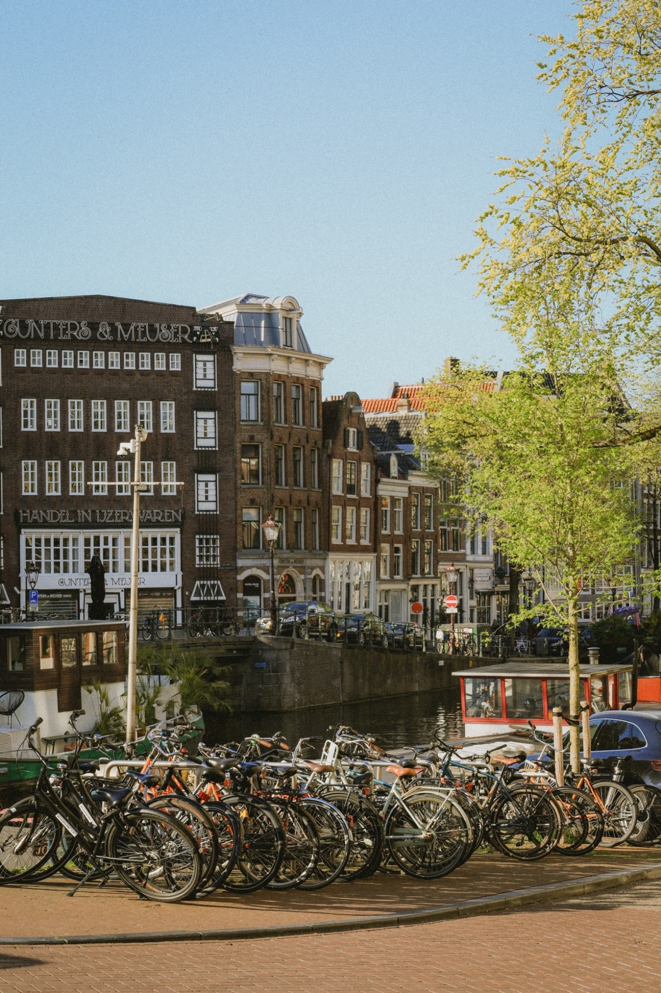 Bikes parked along the canal in Amsterdam. 
