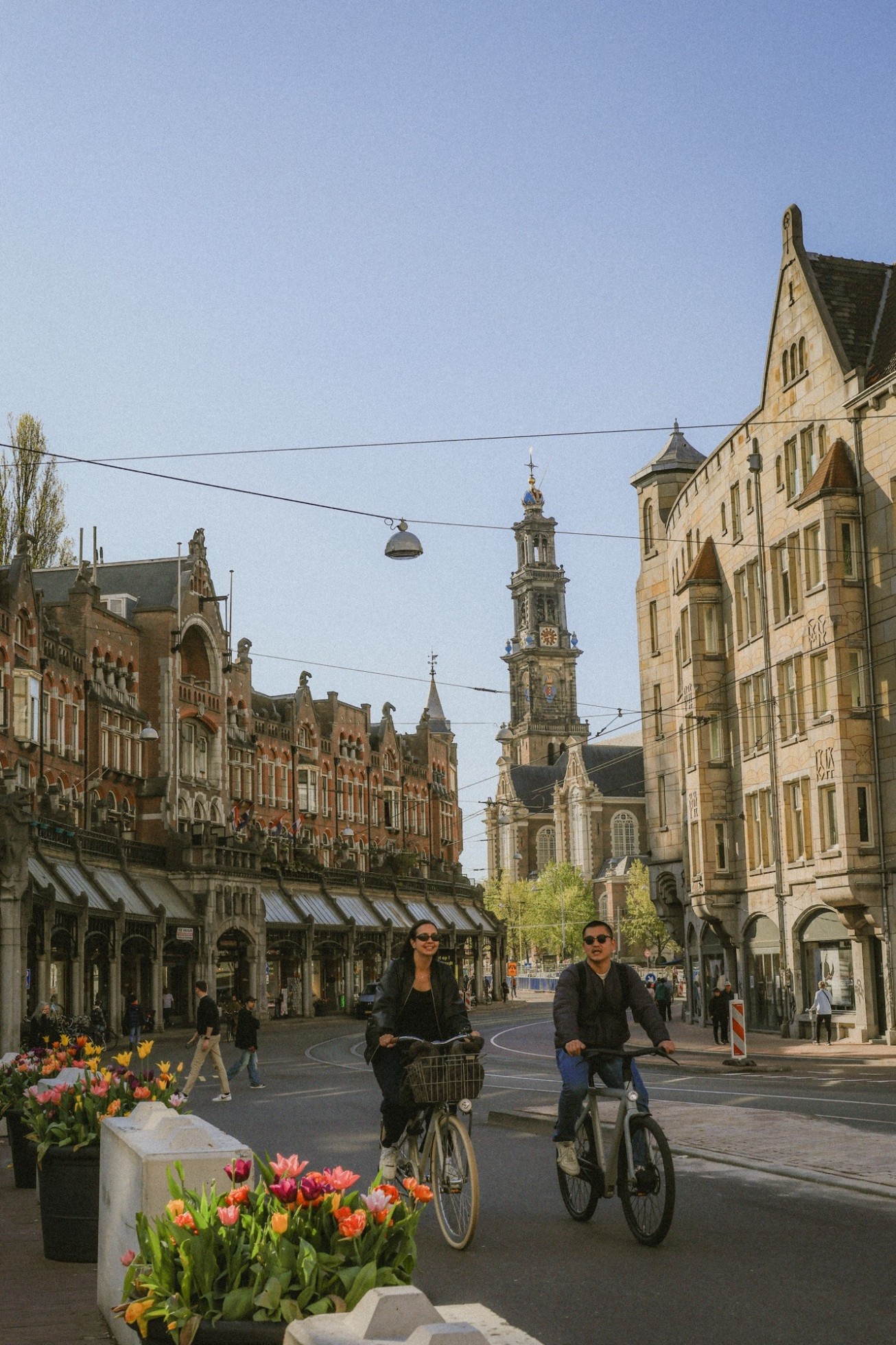 Locals biking through the city of Amsterdam. 
