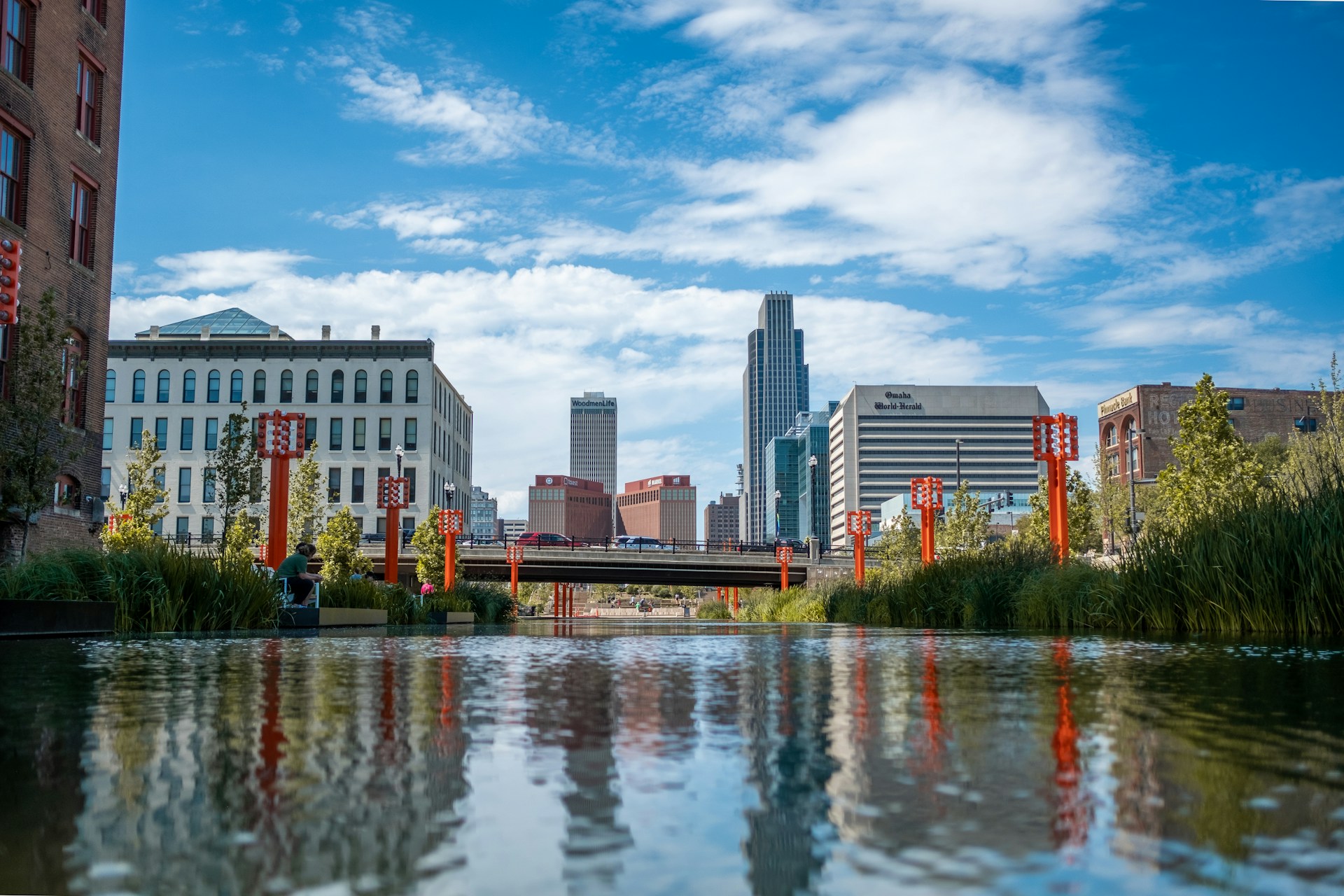 Omaha skyline reflected in water for an article about boring American towns.