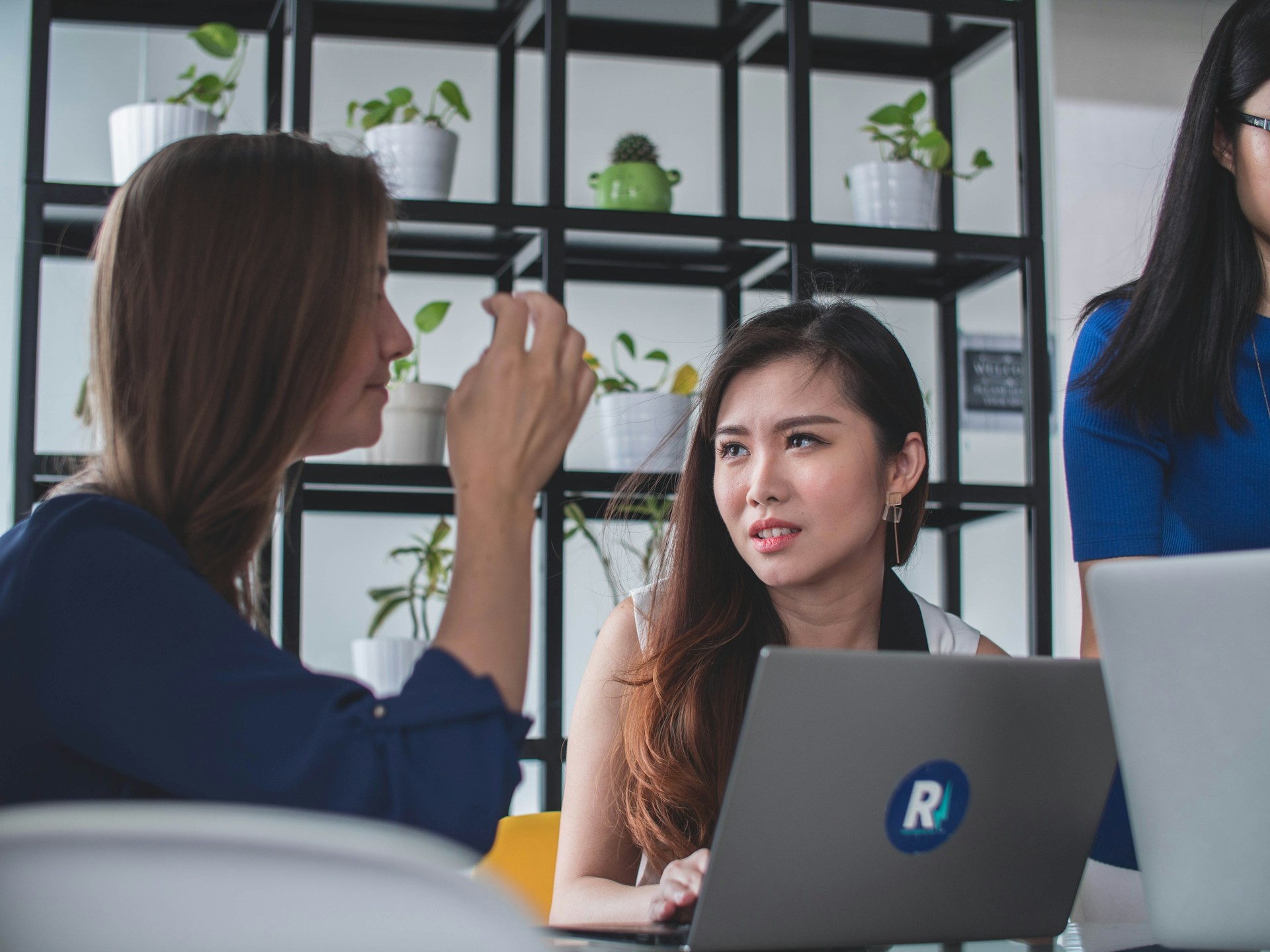 People from different cultural backgrounds having a conversation in an international workplace setting