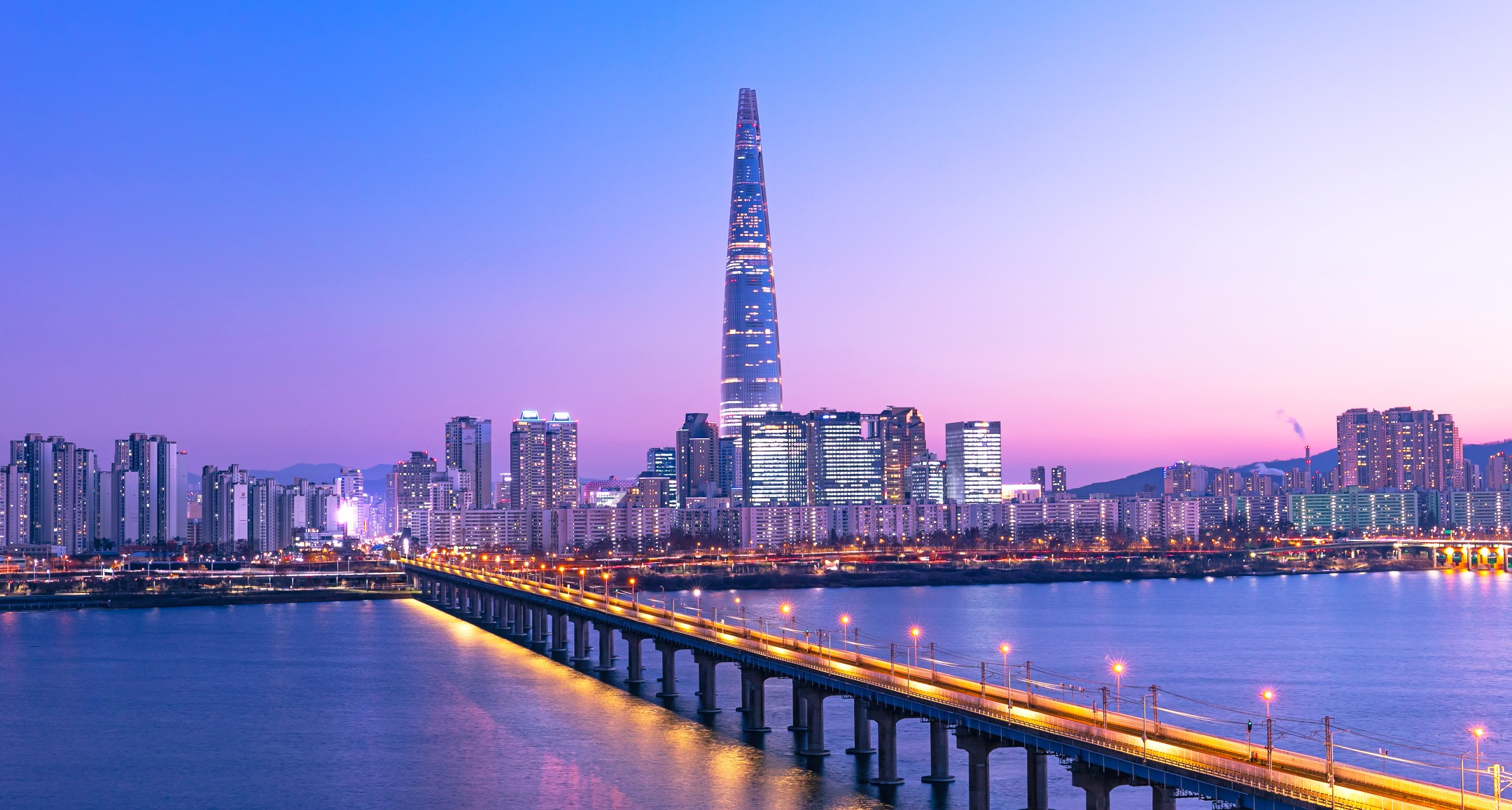 Seoul skyline at sunset featuring Lotte World Tower and the Han River in South Korea