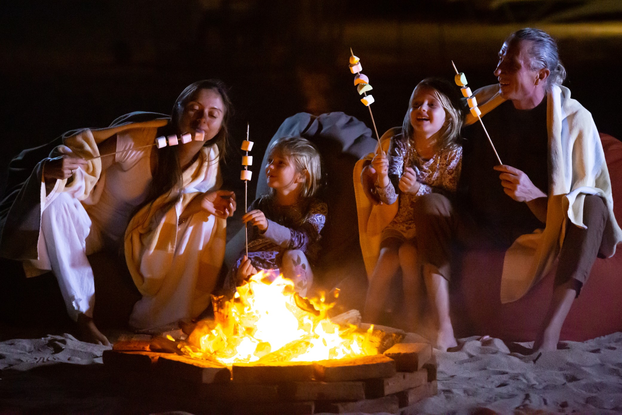 Family enjoying a campfire during a budget-friendly family vacation under $500