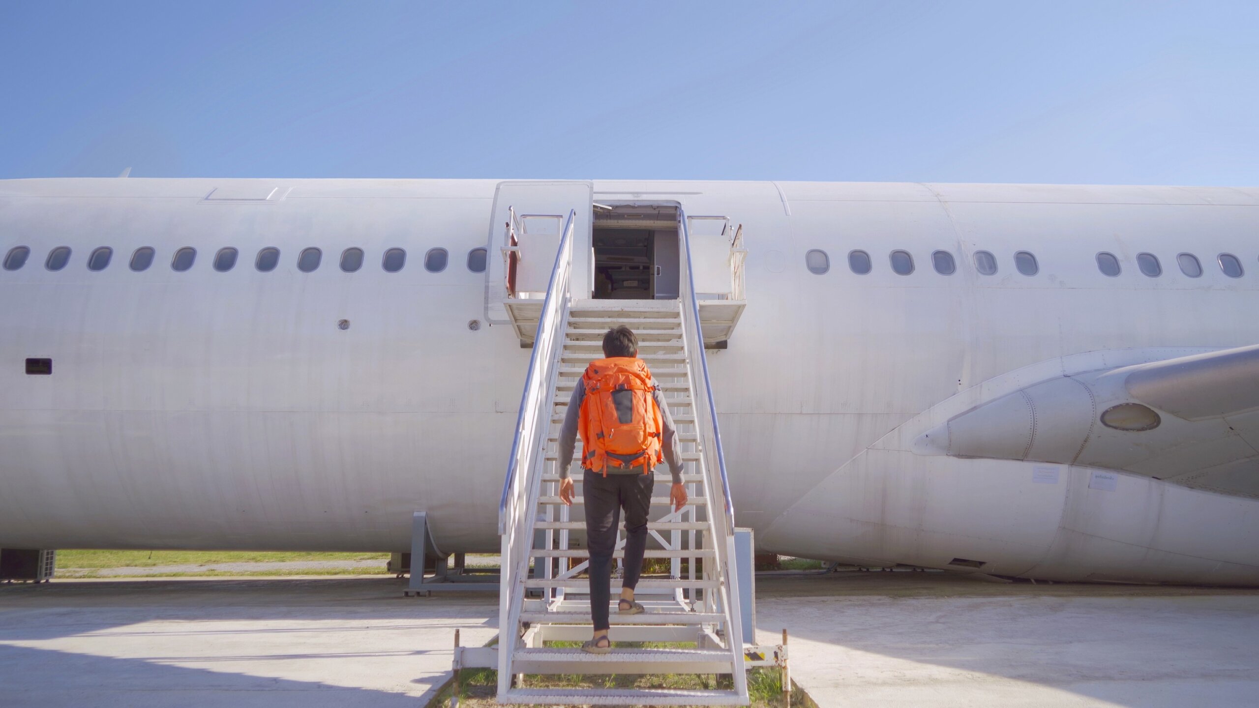 Traveler boarding an airplane after planning a vacation using AI travel tools and trip planners